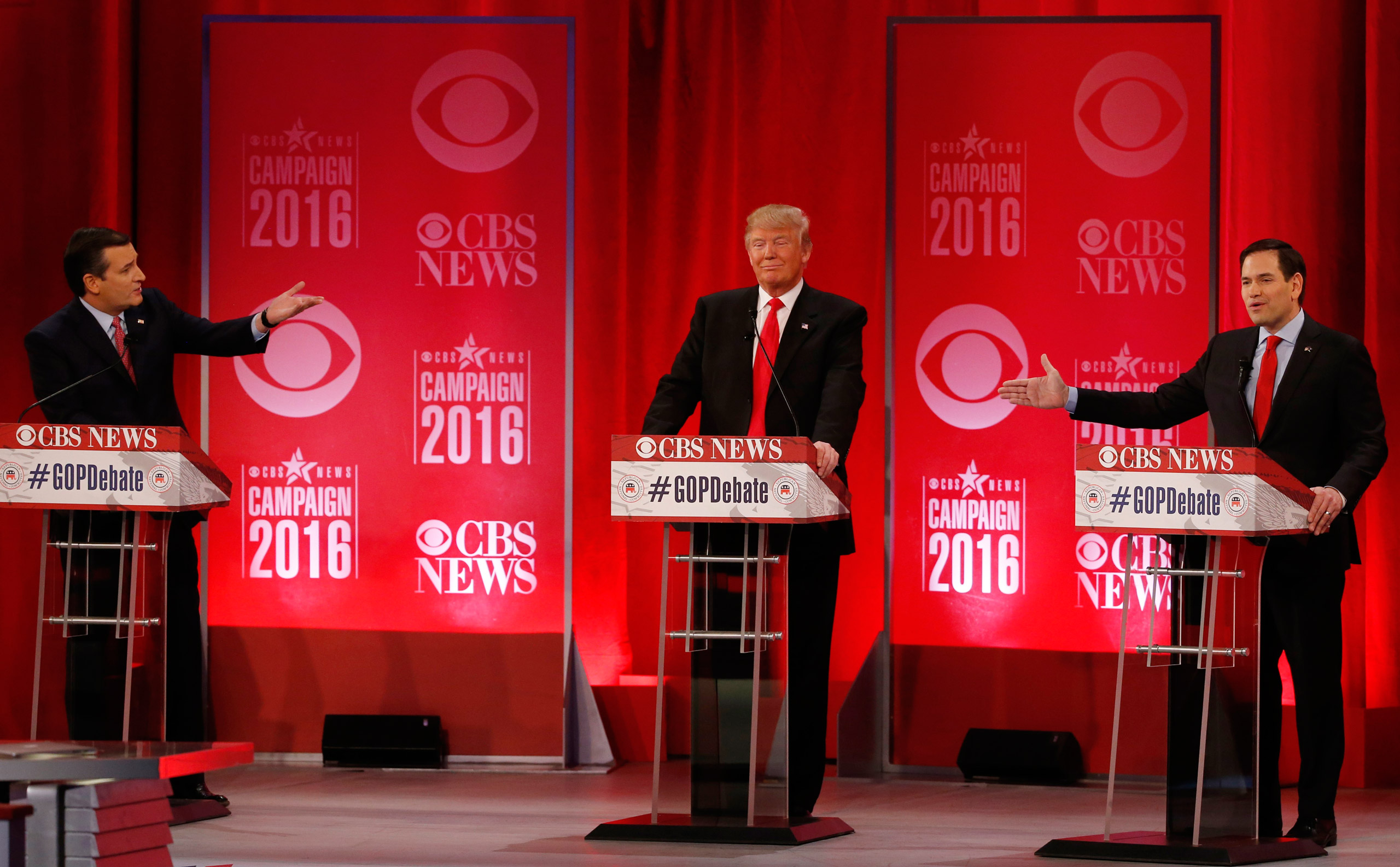 Republican U.S. presidential candidates Senator Ted Cruz (L) and Senator Marco Rubio (R) both gesture at businessman Donald Trump (C) during the Republican U.S. presidential candidates debate sponsored by CBS News and the Republican National Committee in