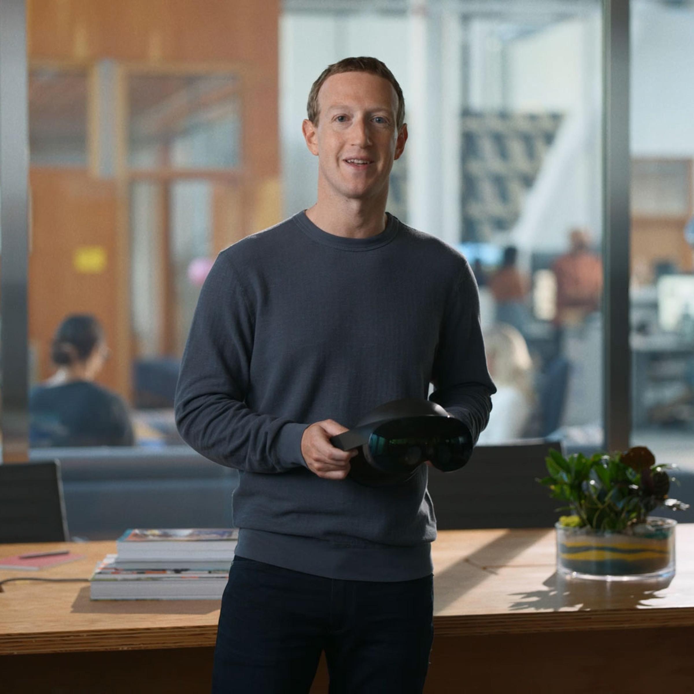 Mark Zuckerberg holds his company's new VR headset, the Meta Quest Pro.