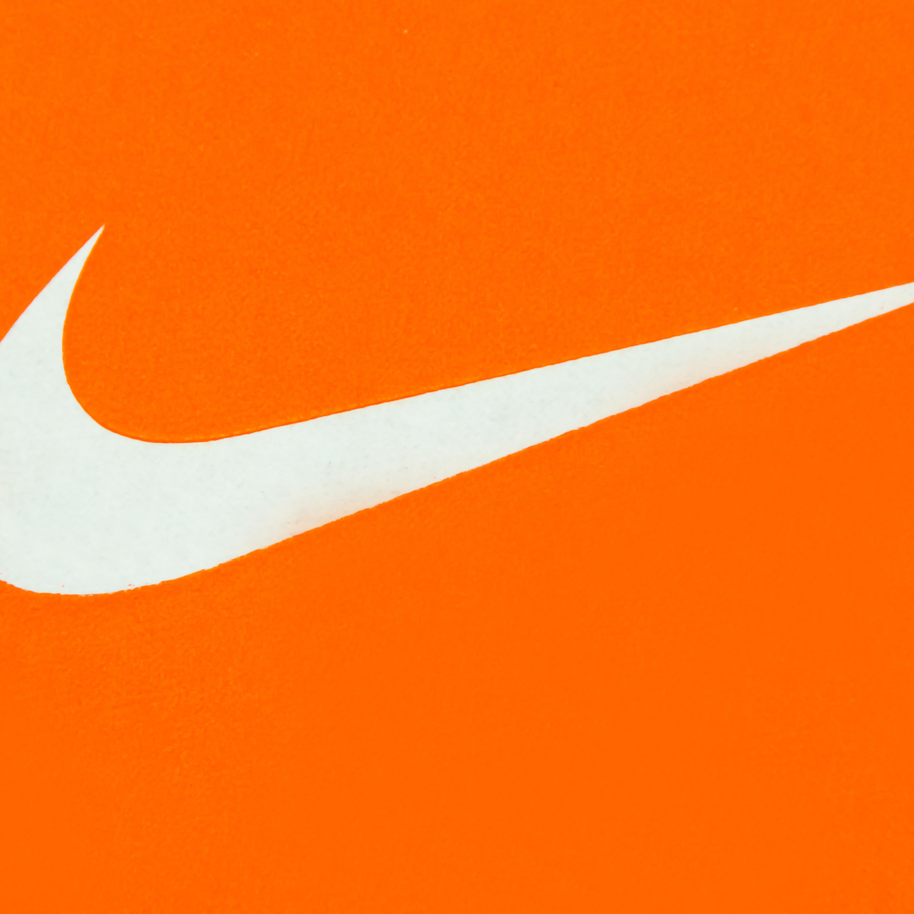White Nike Logo on Orange Background