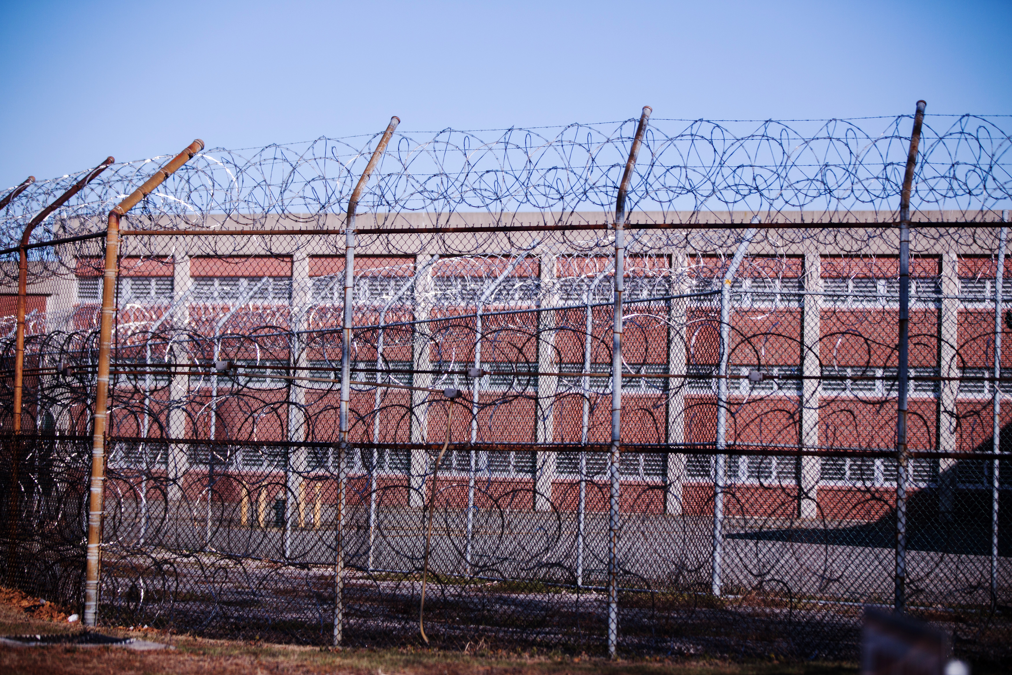 Barbed wire fences surround a building on Rikers Island Correctional Facility in New York on Dec. 24, 2013.