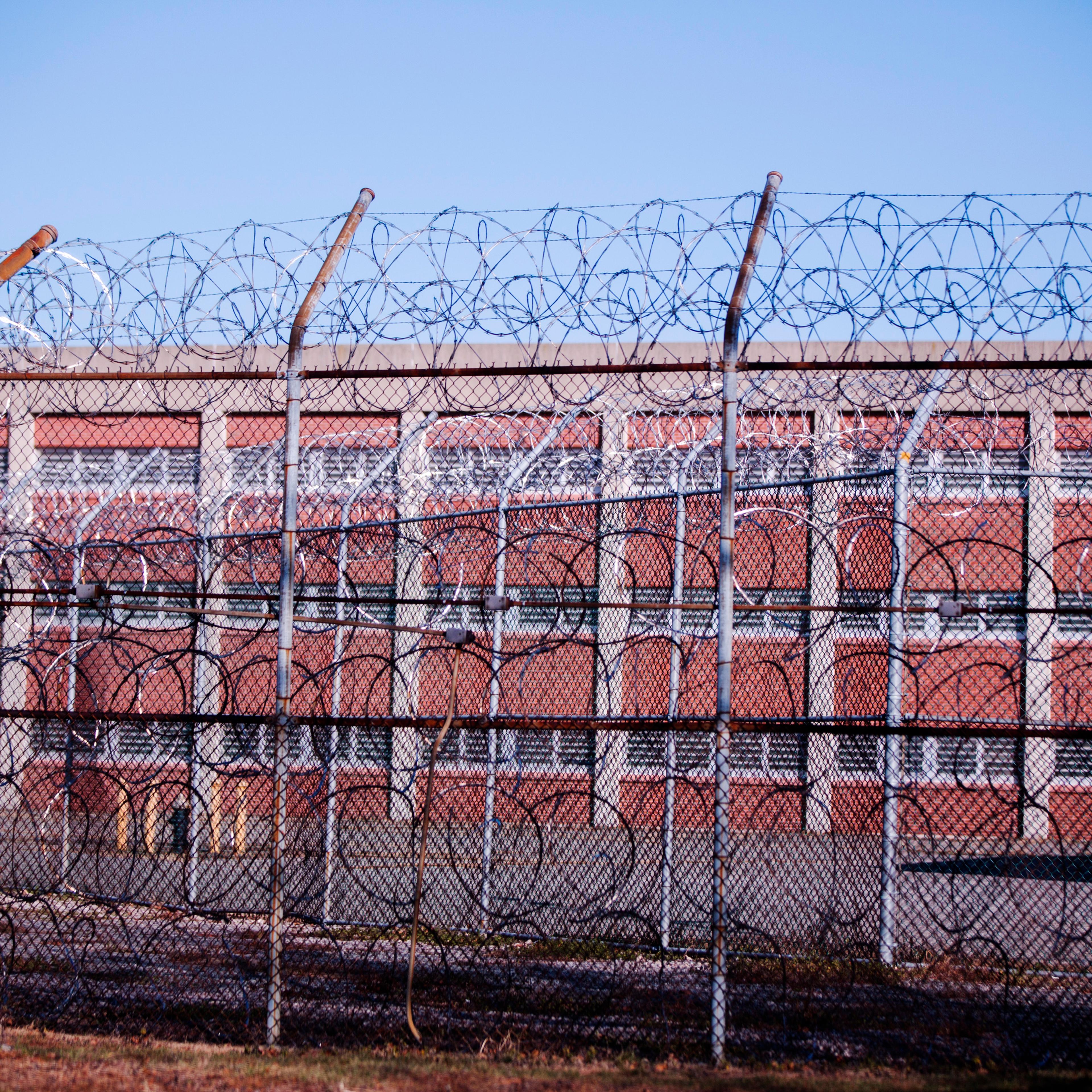 Barbed wire fences surround a building on Rikers Island Correctional Facility in New York on Dec. 24, 2013.