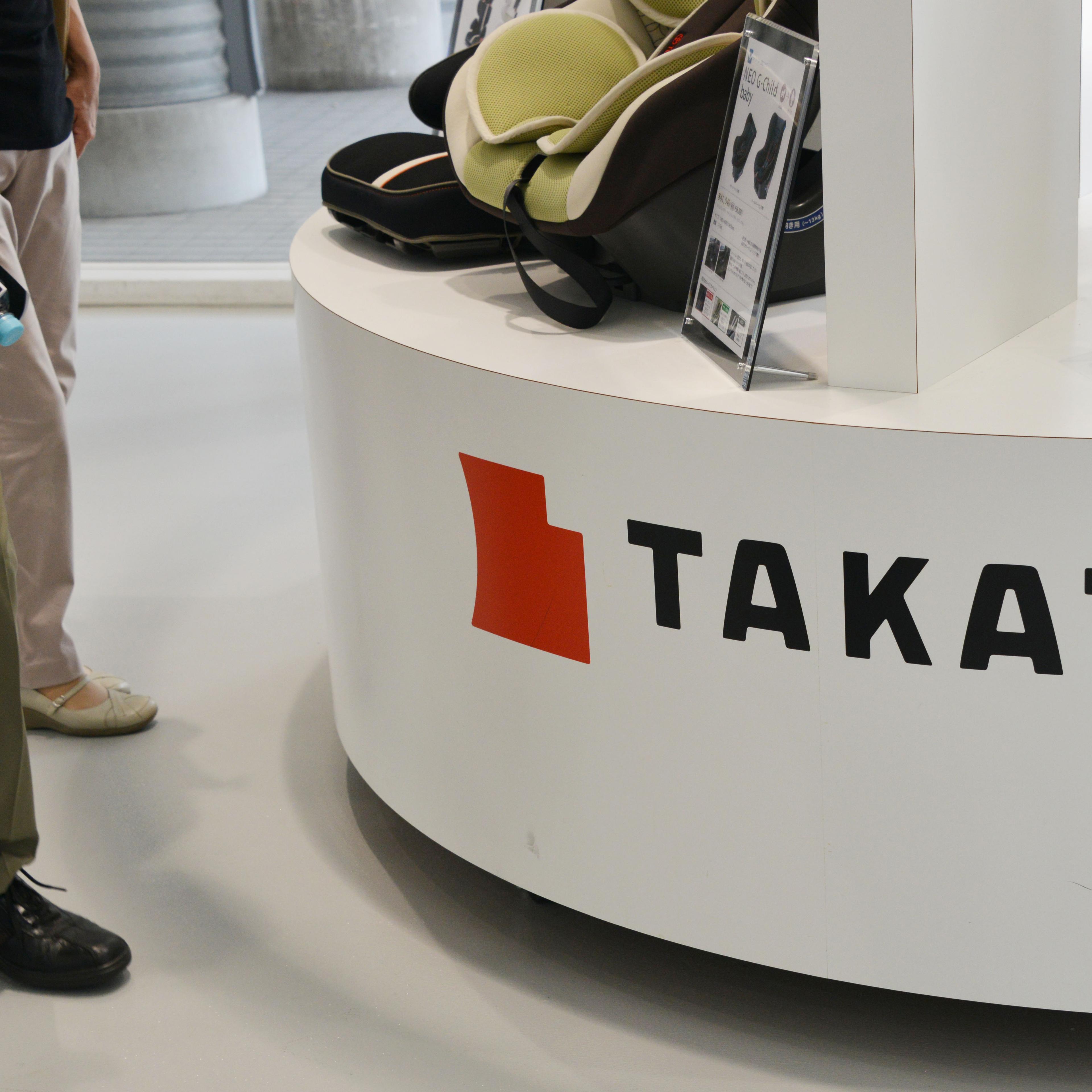 A visitor walks past displays of Takata Corp at a showroom for vehicles in Tokyo, Japan on May 20, 2015.