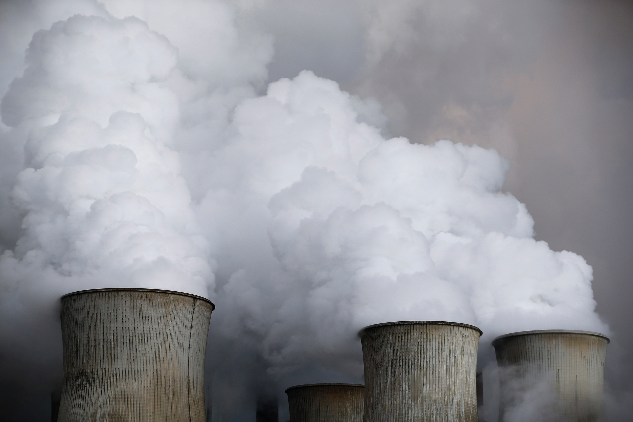 Steam rises from the cooling towers of the coal power plant of RWE, one of Europe's biggest electricity and gas companies in Niederaussem, Germany, March 3, 2016. REUTERS/Wolfgang Rattay/File Photo - RTSPG5G