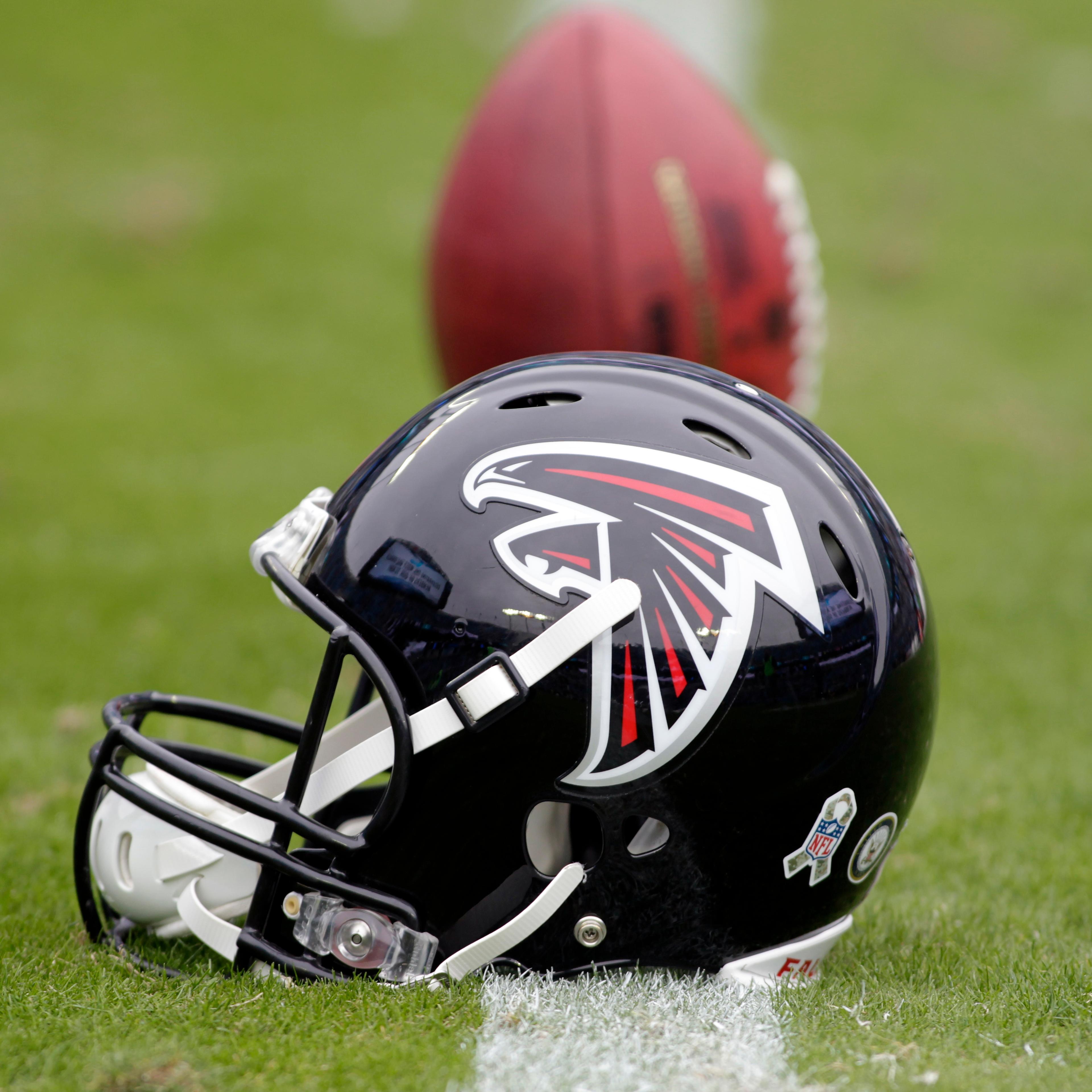 An Atlanta Falcons' helmet sits on the turf before a game against the Carolina Panthers in Charlotte, N.C. on Nov. 16, 2014.