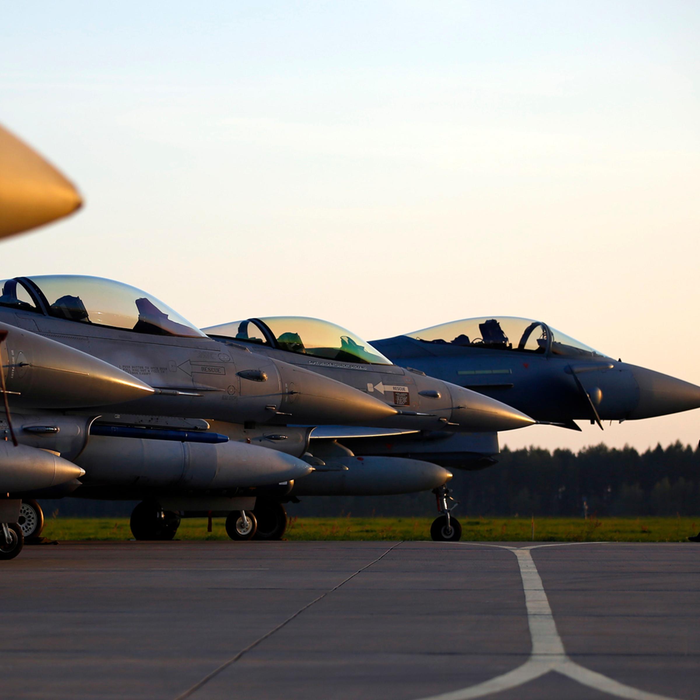 Military aircrafts are seen on the tarmac during a visit of new NATO Secretary-General Stoltenberg of Norway at Lask air base