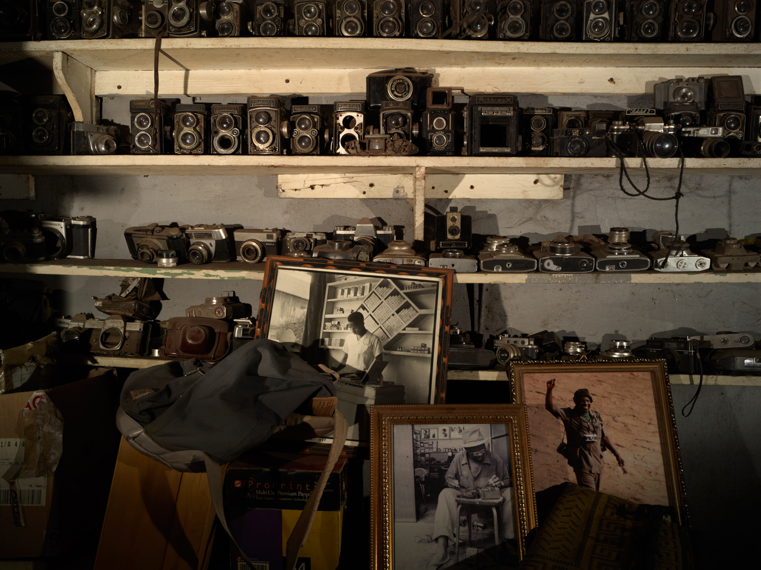 Inside Malick Sidibe's Bamako studio, a collection of Sidibe's old cameras takes up an entire wall.