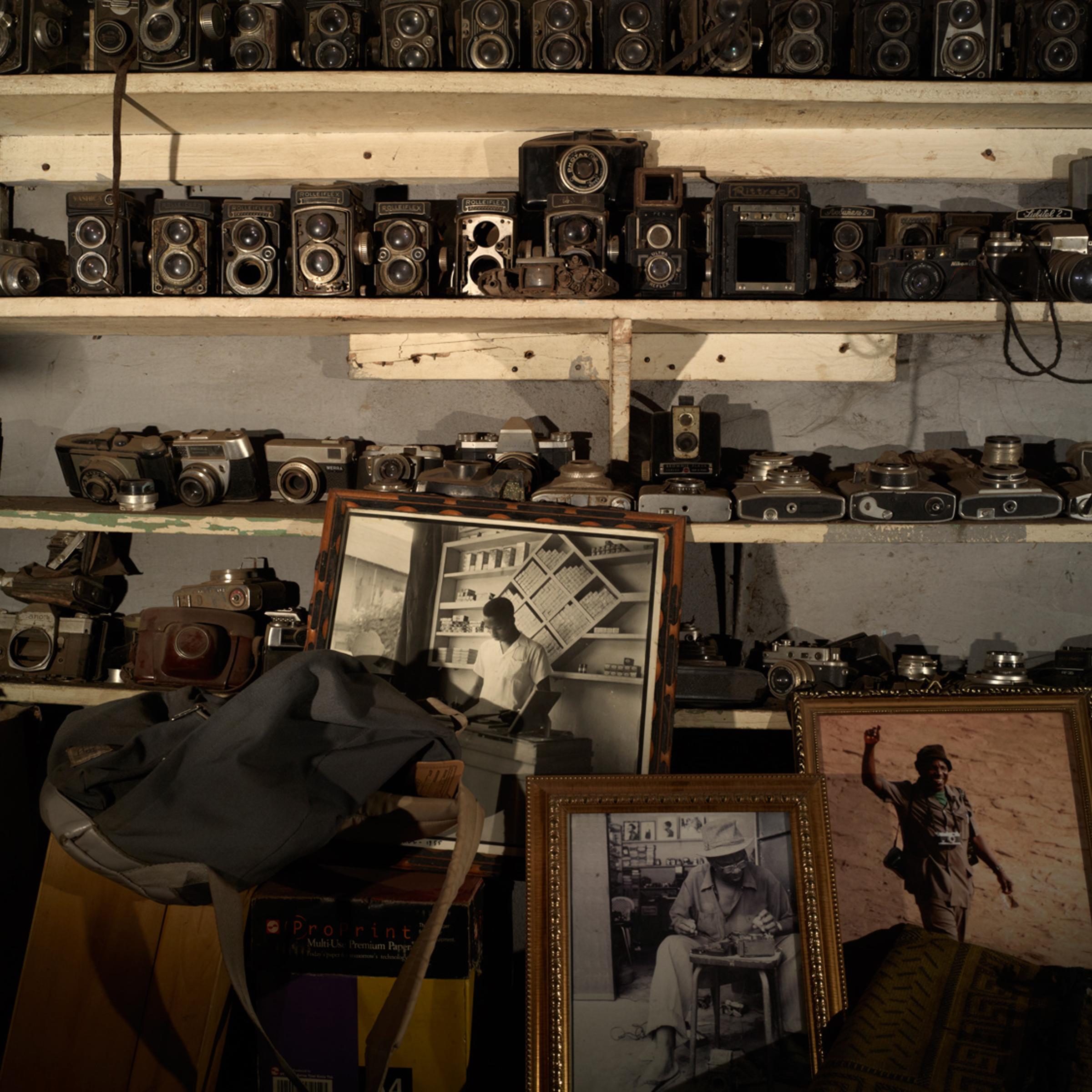 Inside Malick Sidibe's Bamako studio, a collection of Sidibe's old cameras takes up an entire wall.