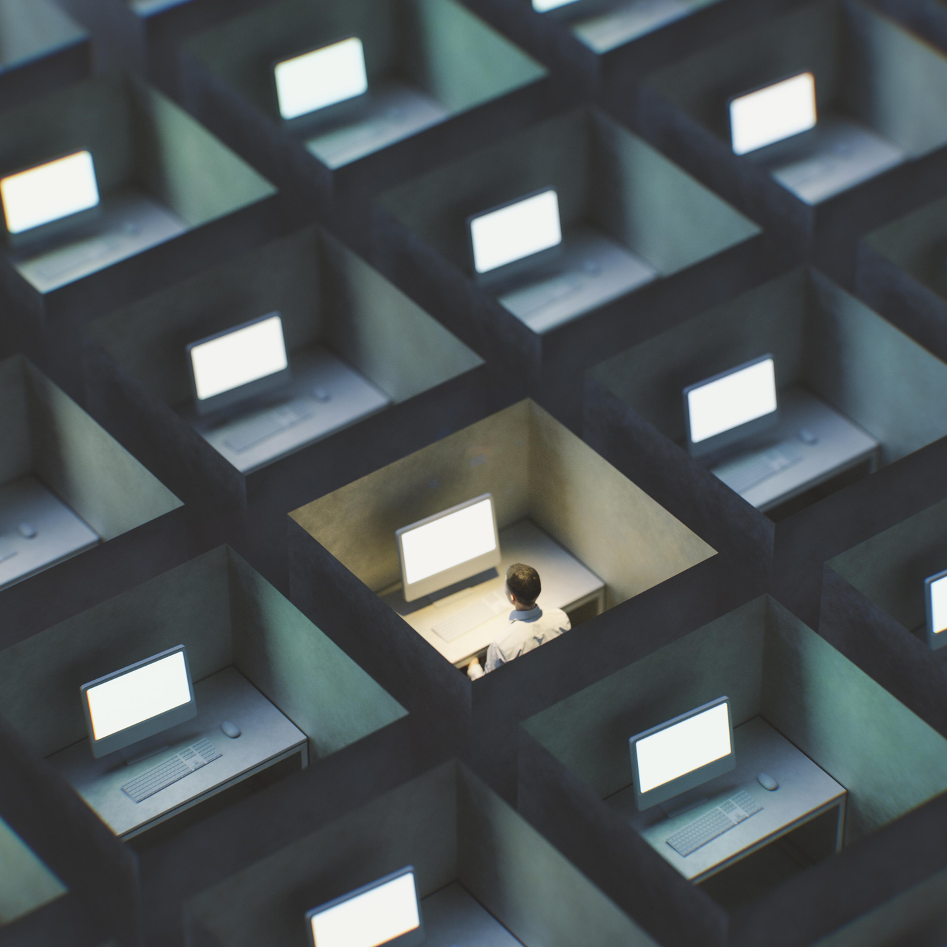 Office cubicles with man working late