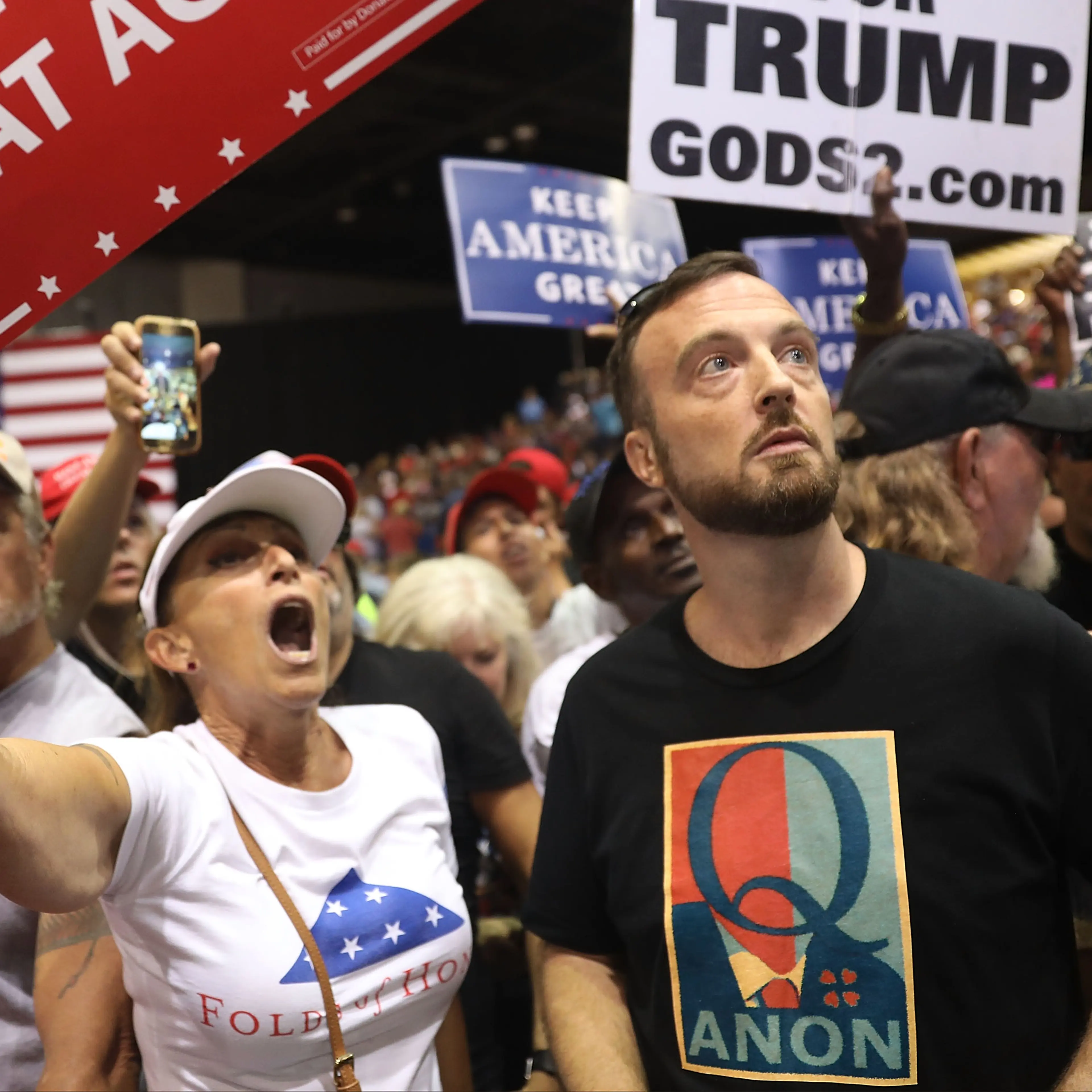 A man with the words Q Anon on his shirt at the Trump rally