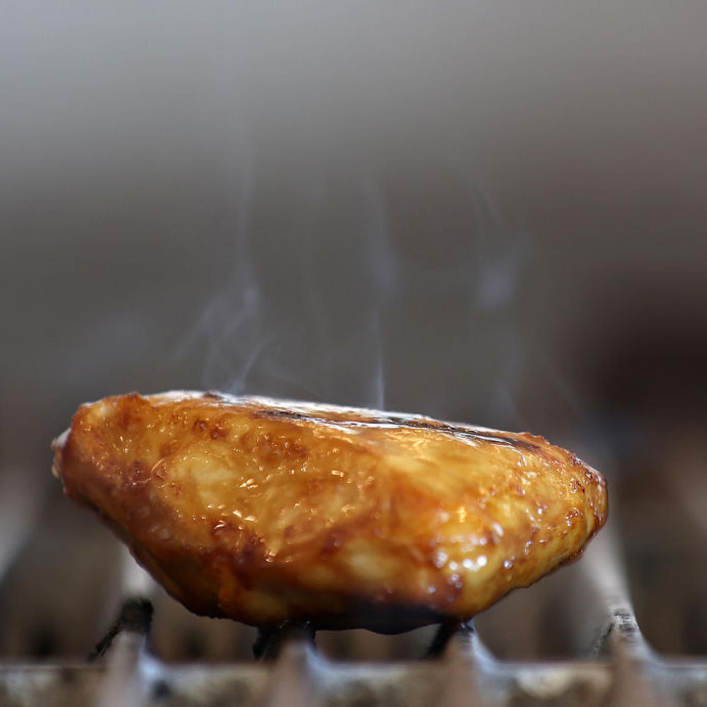 A piece of Good Meat's cultivated chicken cooks on a grill at the Eat Just office on July 27, 2023 in Alameda, California.