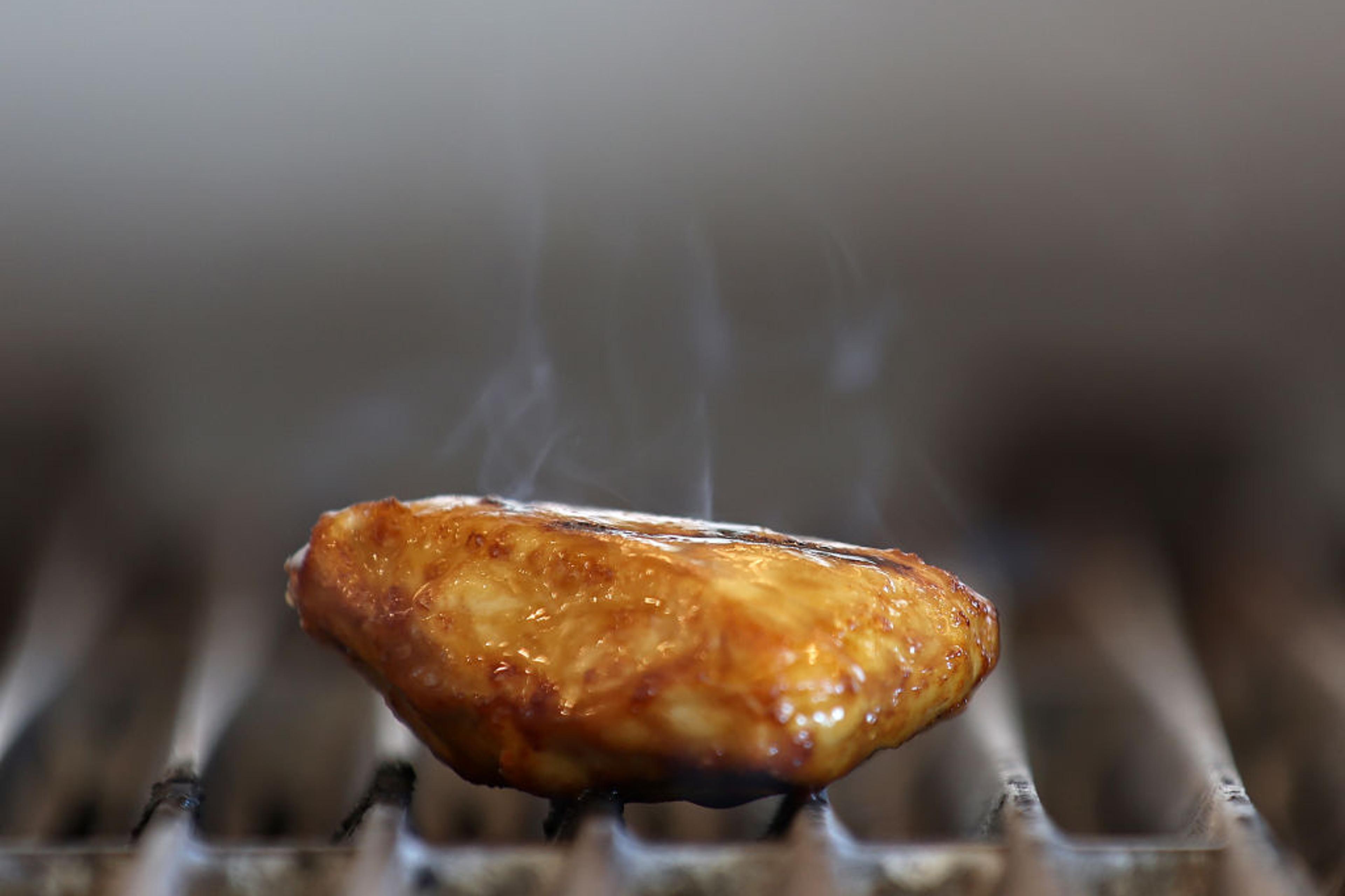 A piece of Good Meat's cultivated chicken cooks on a grill at the Eat Just office on July 27, 2023 in Alameda, California.