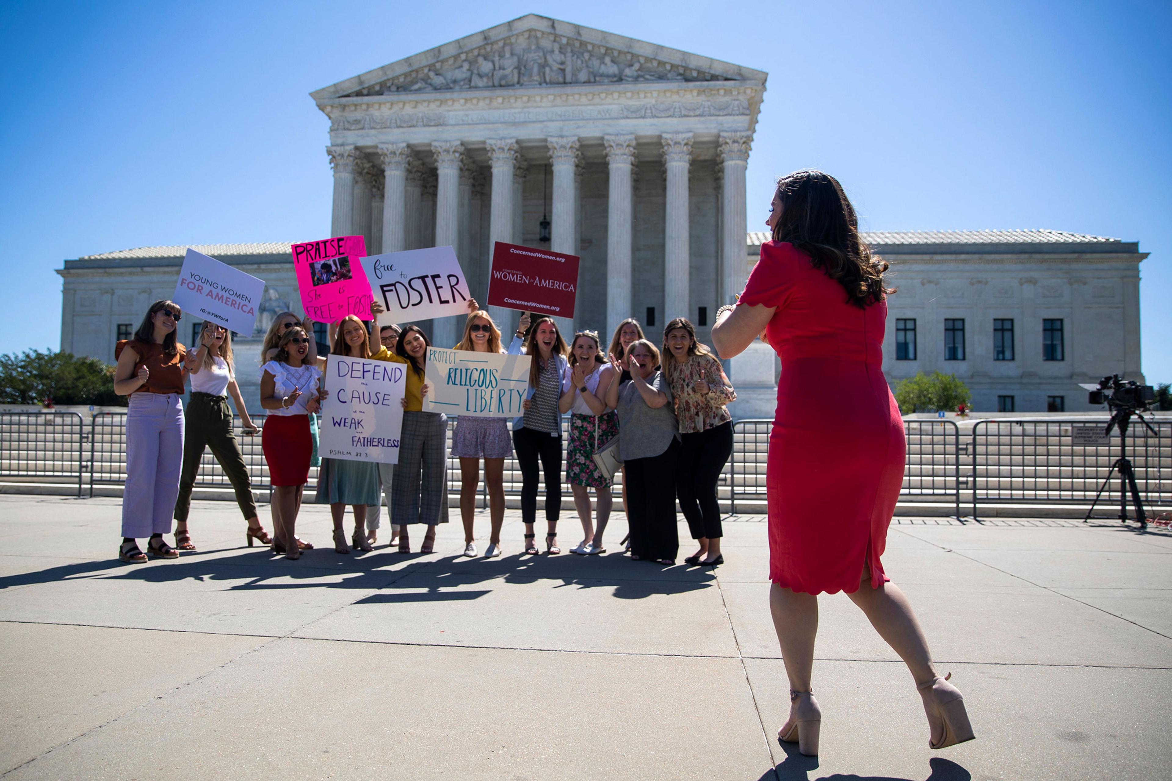 People stand in front of the Supreme Court in Washington, DC, USA, 17 June 2021. The Supreme Court dismissed a challenge to the Affordable Care Act and delivered a unanimous defeat to LGBT couples in a case over whether the city of Philadelphia could ref
