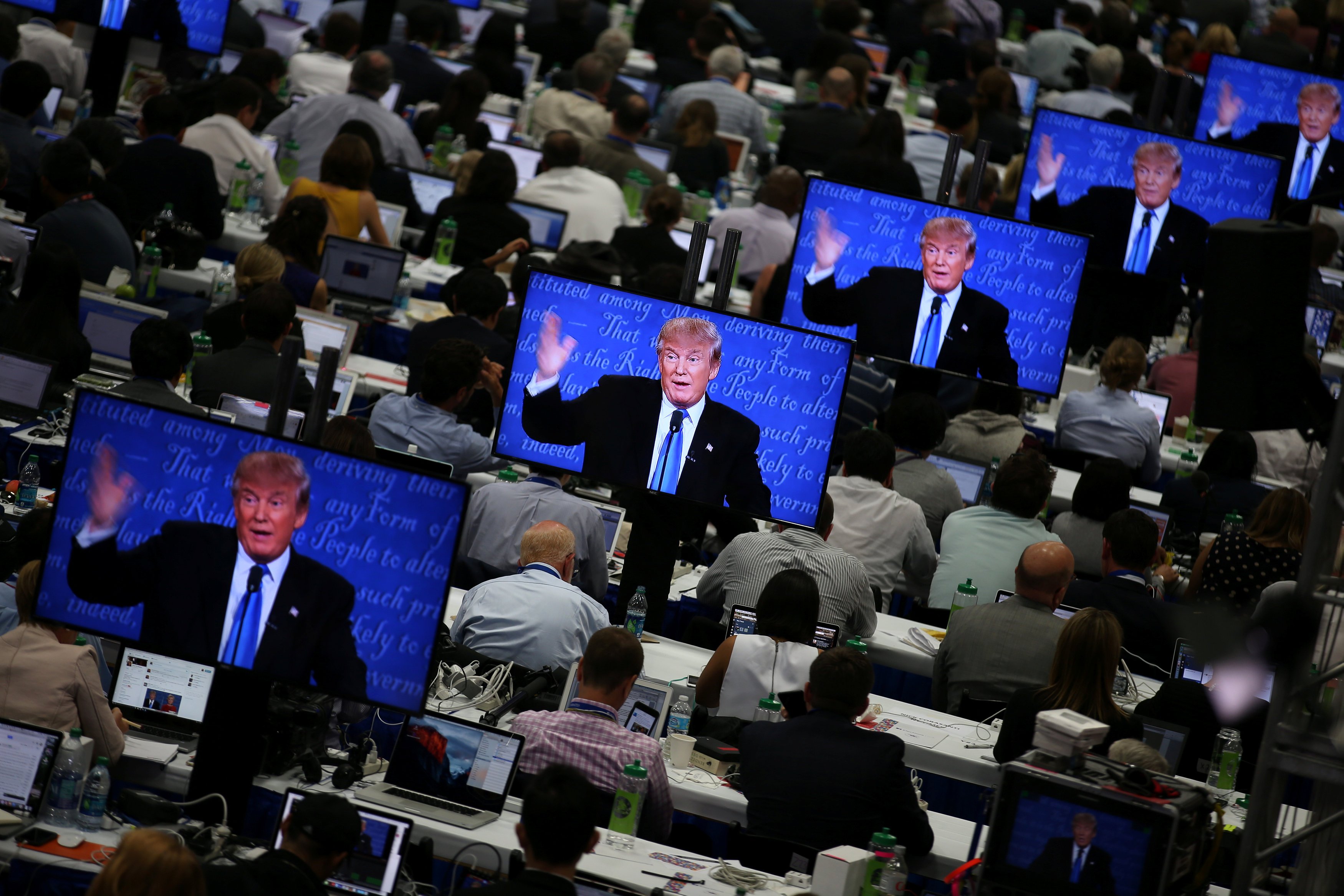 Republican presidential nominee Donald Trump is seen on television screens at the media room during the first presidential debate with U.S. Democratic presidential candidate Hillary Clinton at Hofstra University in Hempstead, New York, U.S., Sept.r 26, 2
