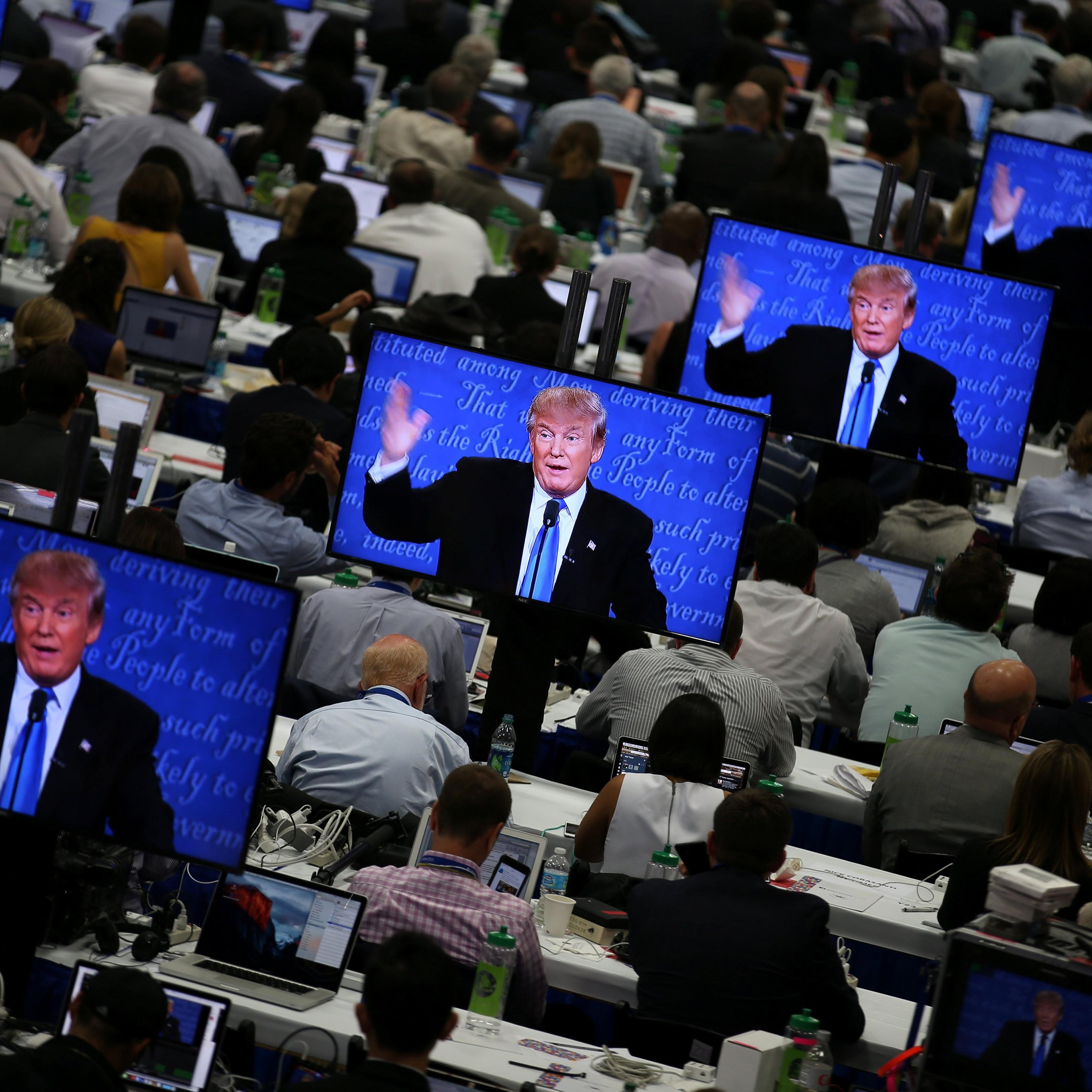 Republican presidential nominee Donald Trump is seen on television screens at the media room during the first presidential debate with U.S. Democratic presidential candidate Hillary Clinton at Hofstra University in Hempstead, New York, U.S., Sept.r 26, 2