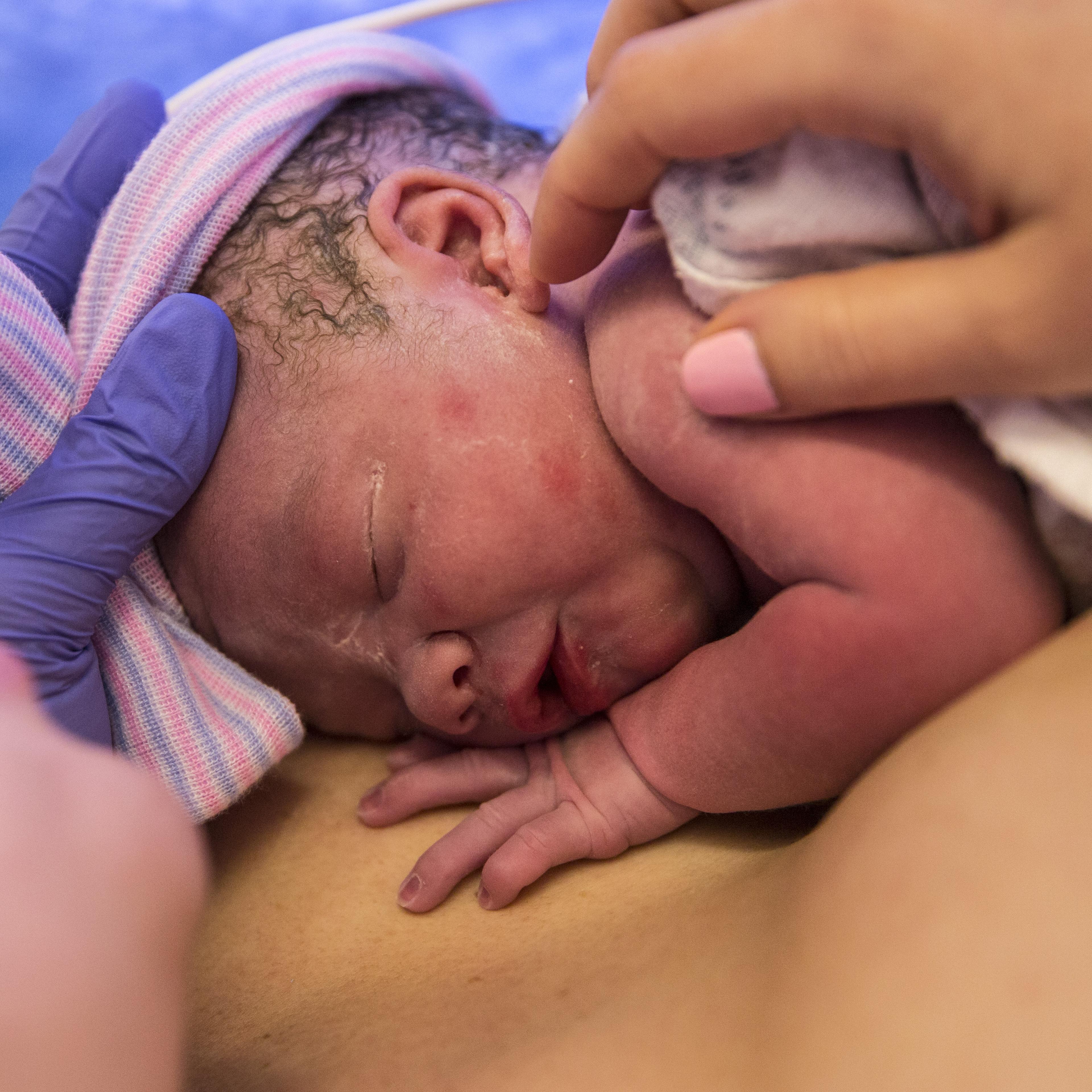 The mother holding her baby in the delivery room in February 2018.