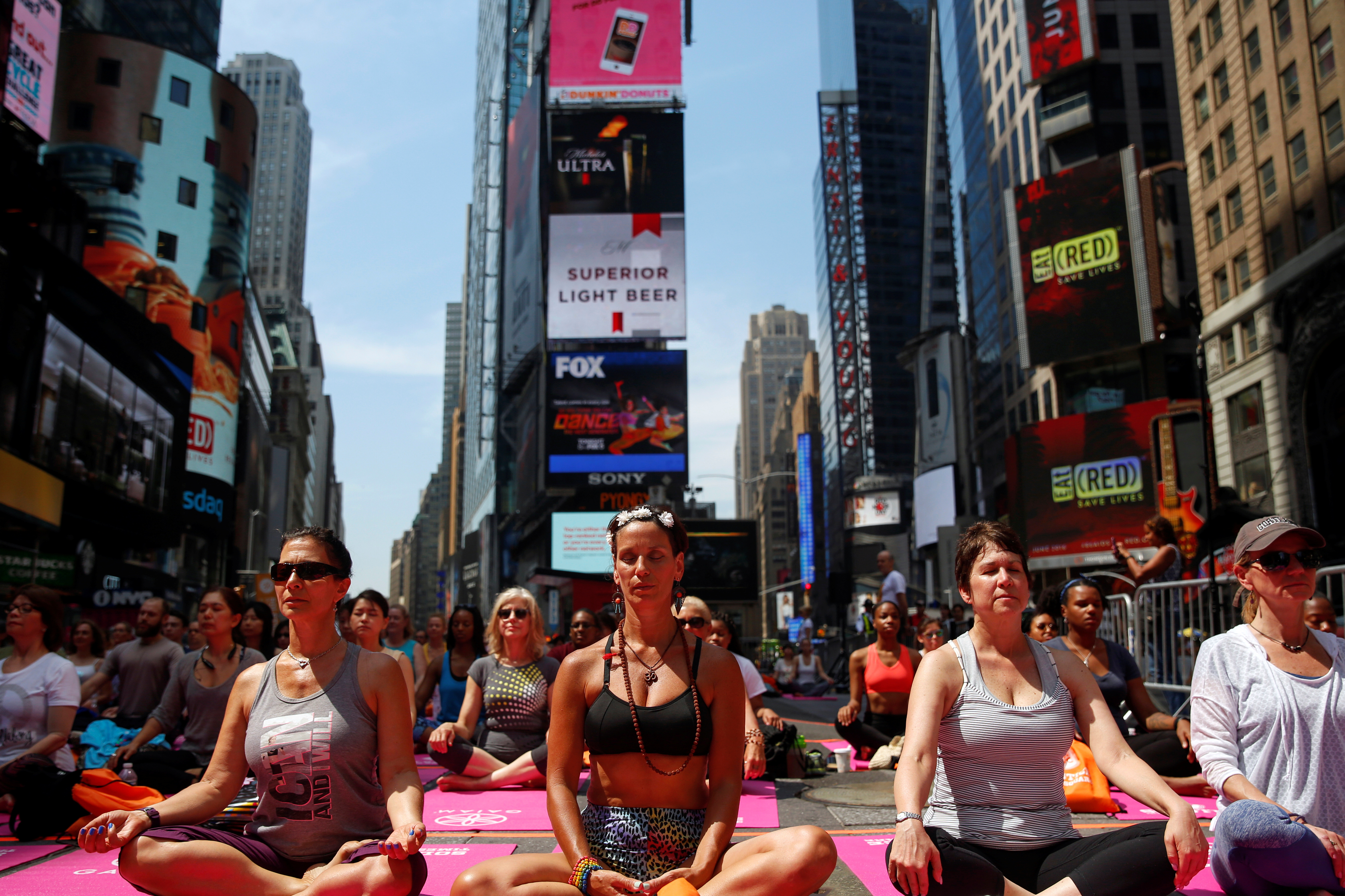 People participate in a yoga class during the 14th Annual Solstice in Times Square event in New York