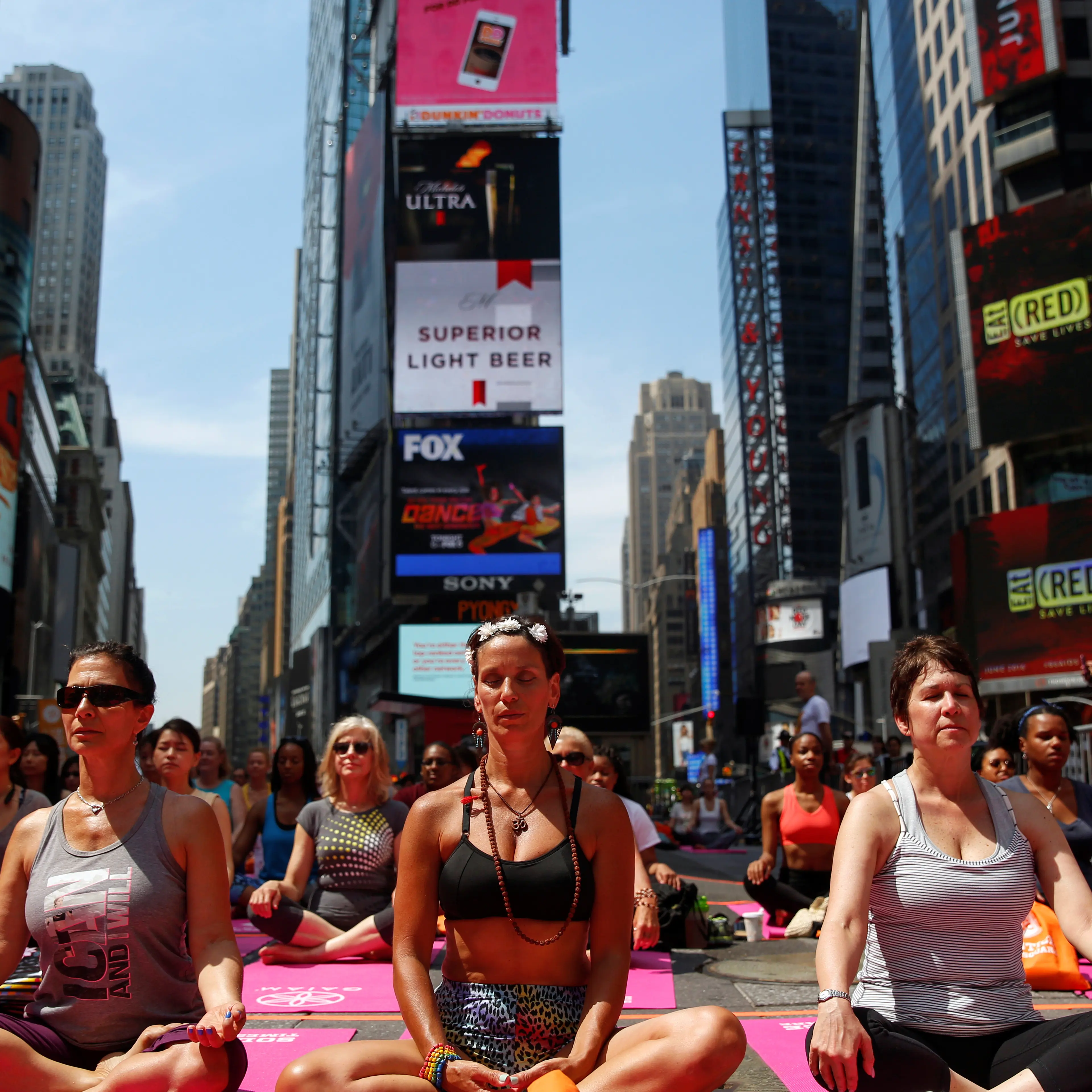 People participate in a yoga class during the 14th Annual Solstice in Times Square event in New York
