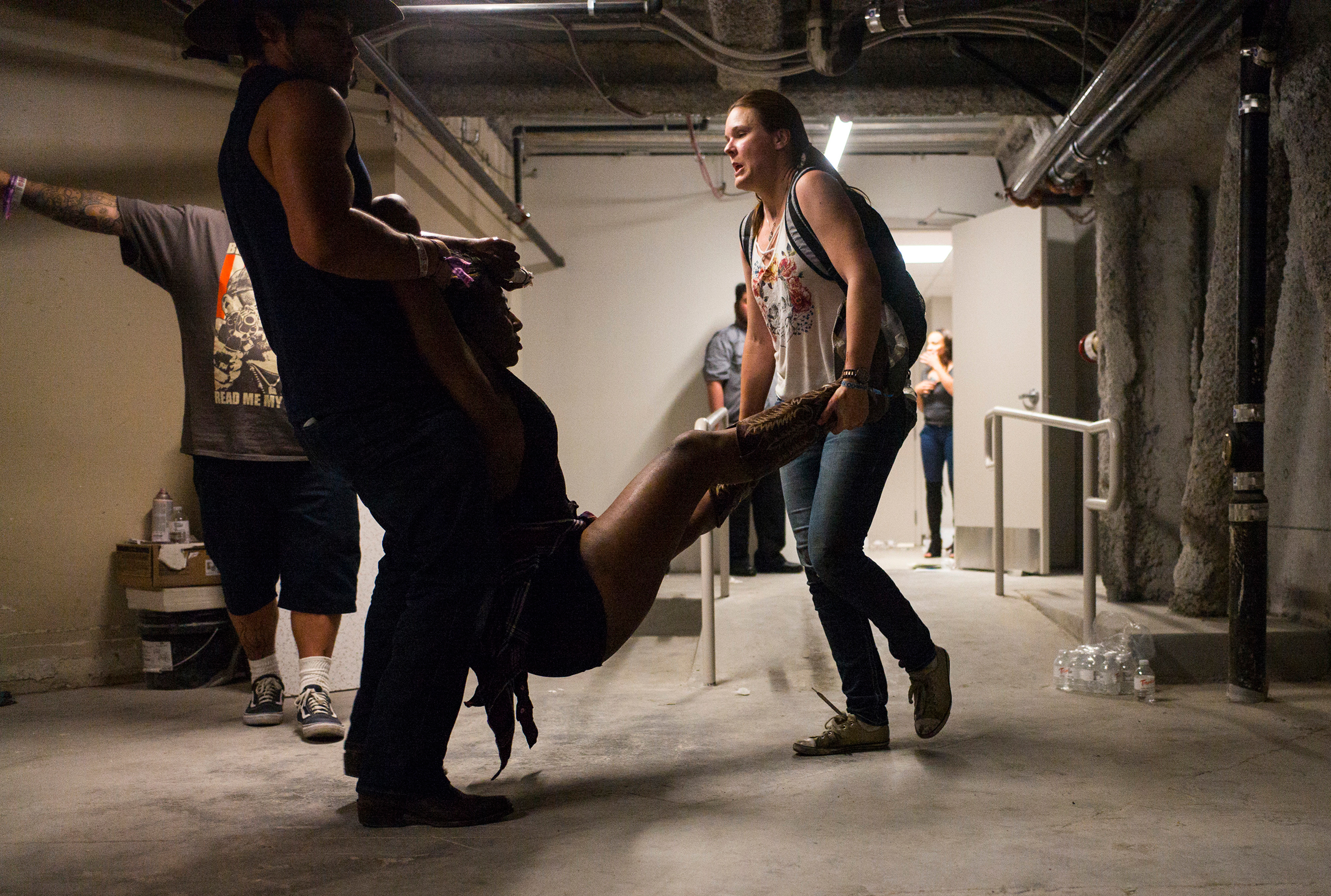 A woman is carried through the Tropicana by a man and woman after the mass shooting in Las Vegas on Oct. 1, 2017.