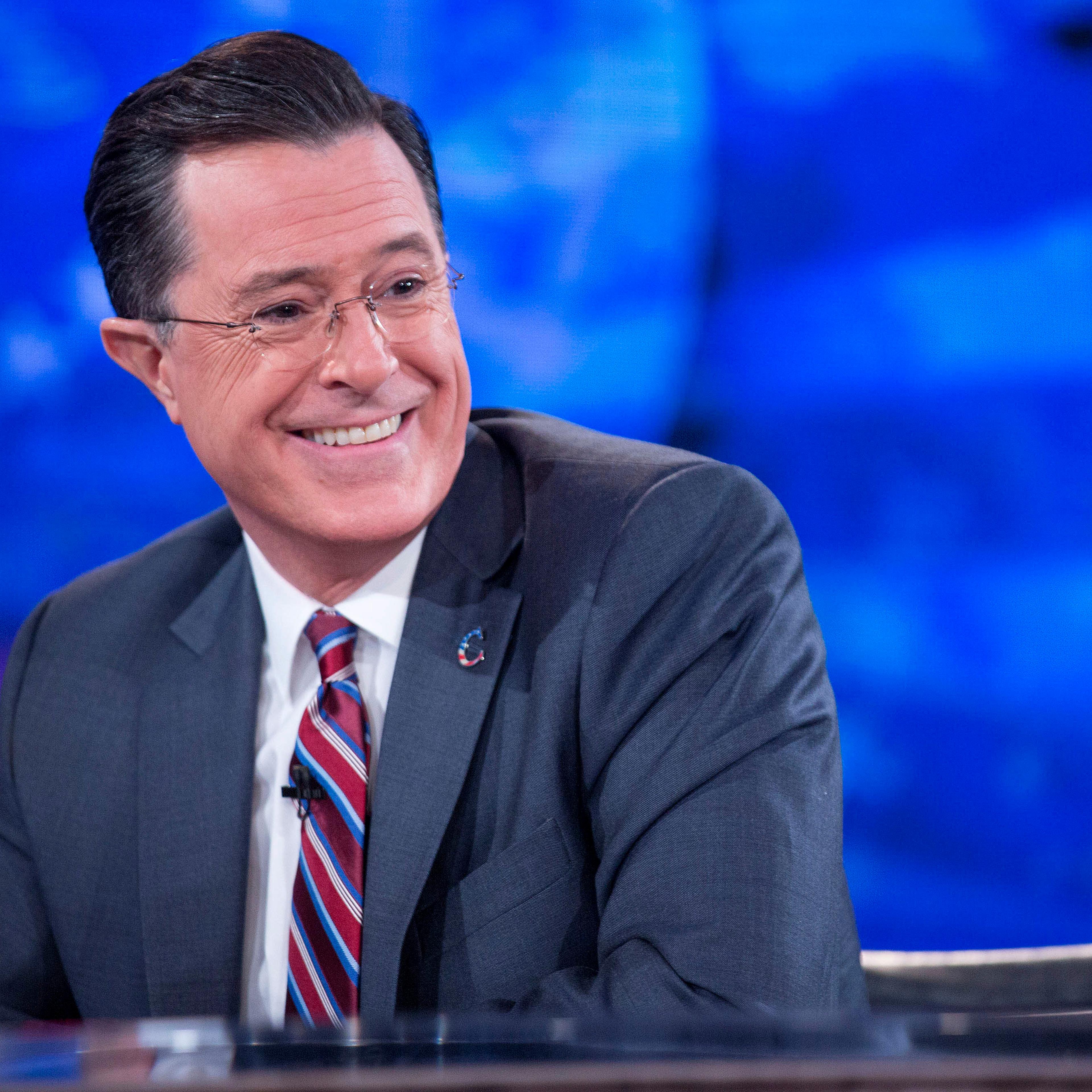 Stephen Colbert smiles while taping the "The Colbert Report" with U.S. President Barack Obama, not pictured, in Lisner Auditorium at George Washington University in Washington, D.C., on Dec. 8, 2014.