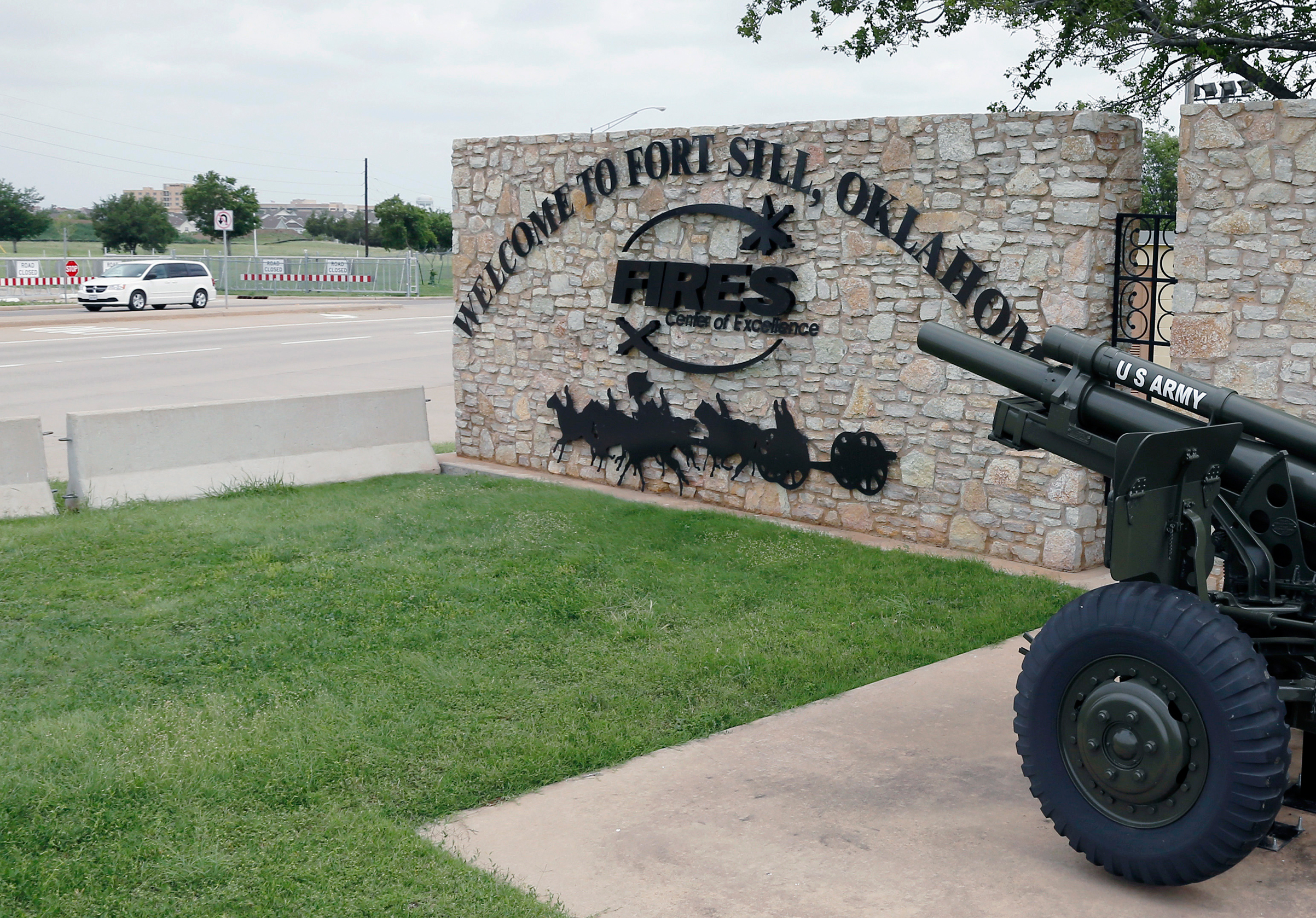 A vehicle drives by a sign at one of the entrances to Fort Sill in Oklahoma on June 17, 2014.