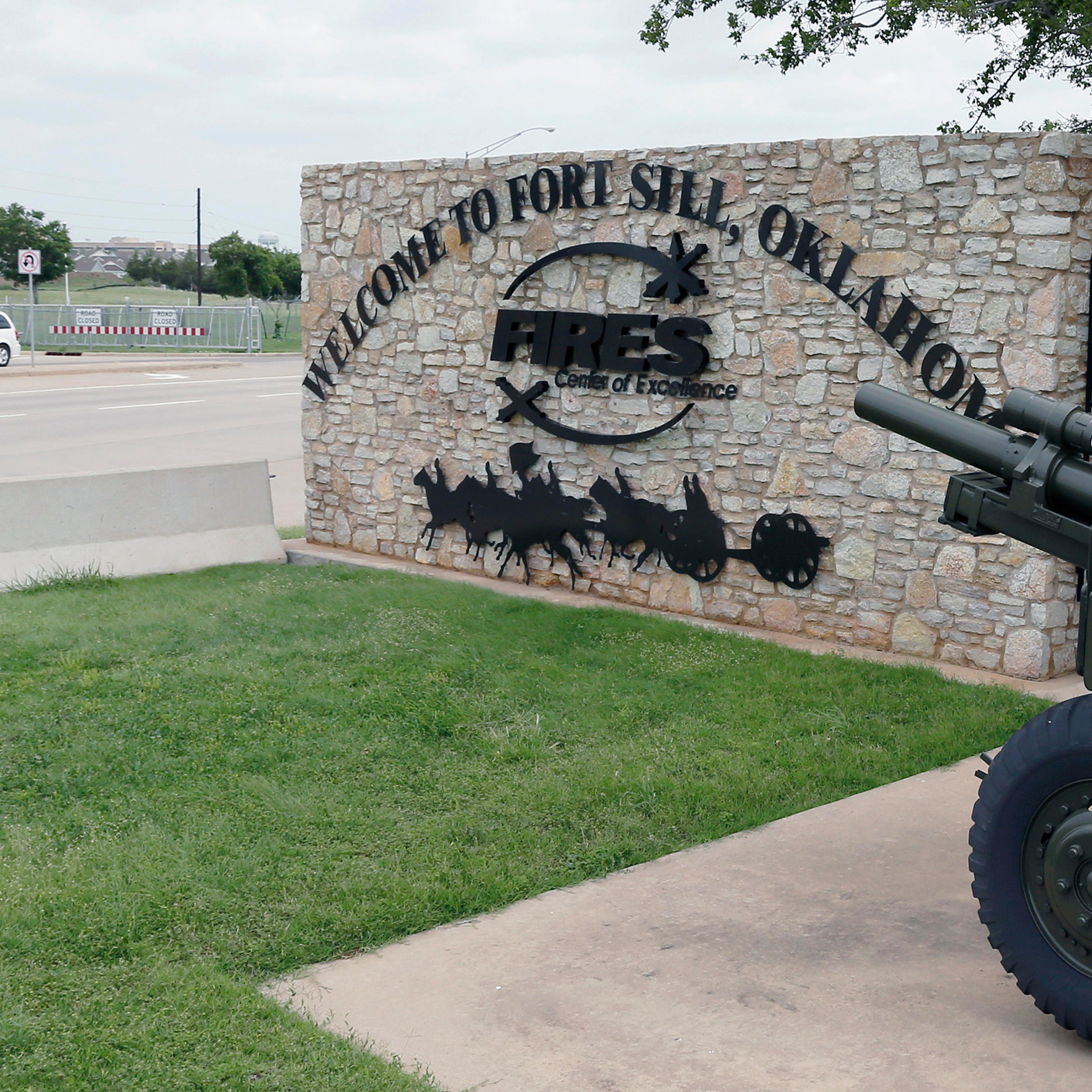 A vehicle drives by a sign at one of the entrances to Fort Sill in Oklahoma on June 17, 2014.