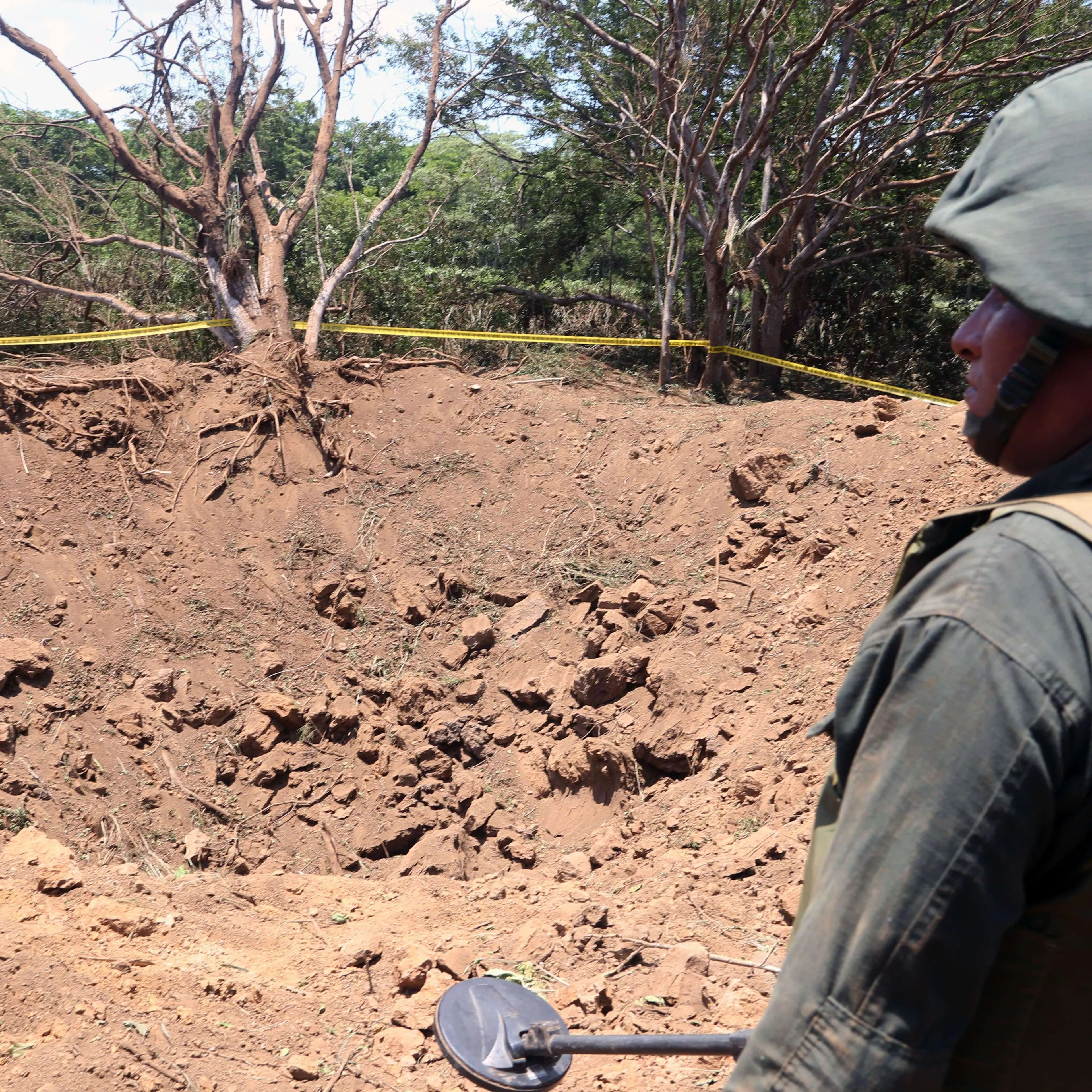 A Nicaraguan soldier checks the site where an alleged meteorite struck on Sept. 7, 2014 in Managua.