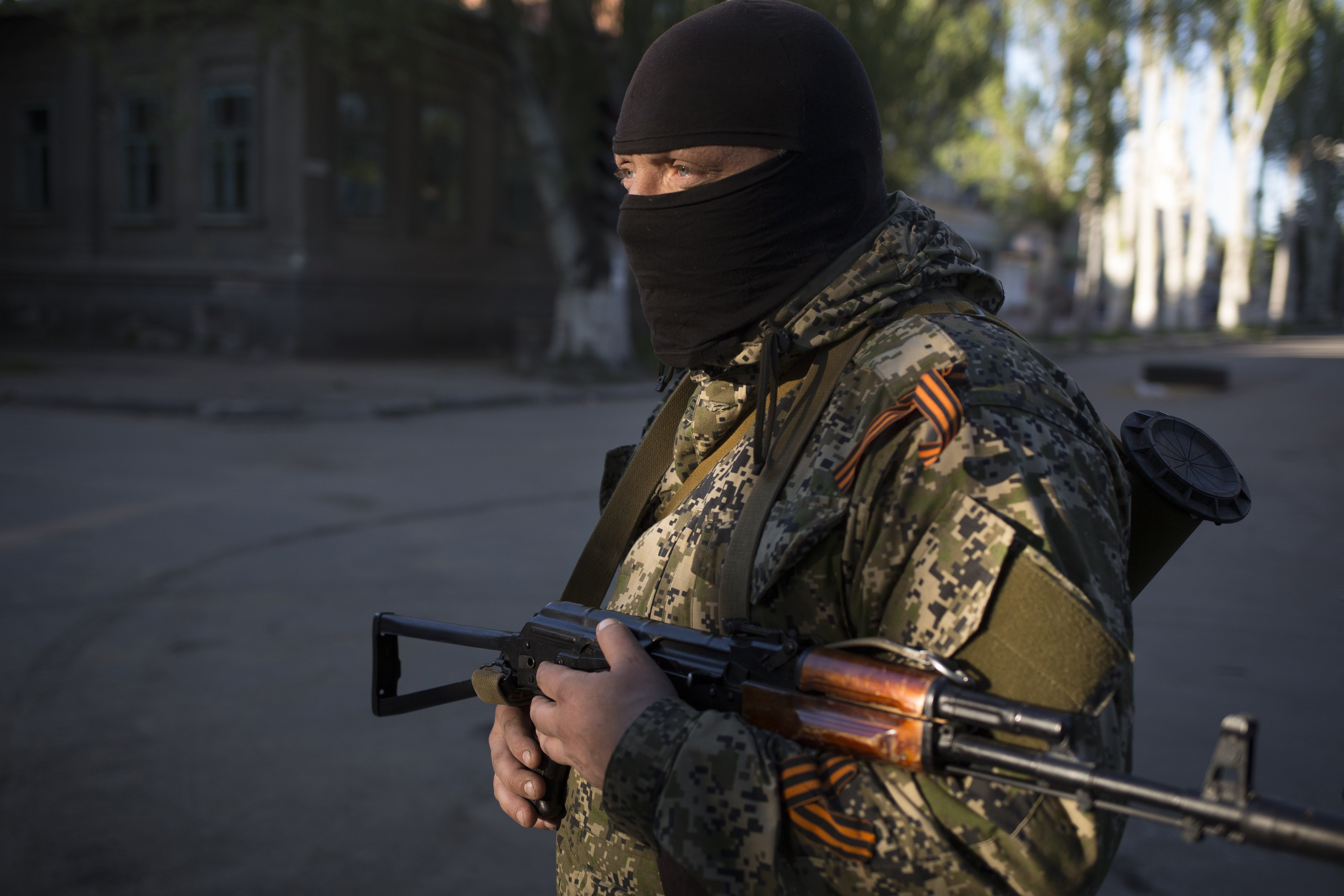 A man guards a road intersection as pro-Russian activists strengthen the barricades in front of the Ukrainian regional office of the Security Service in Slavyansk, May 7, 2014.