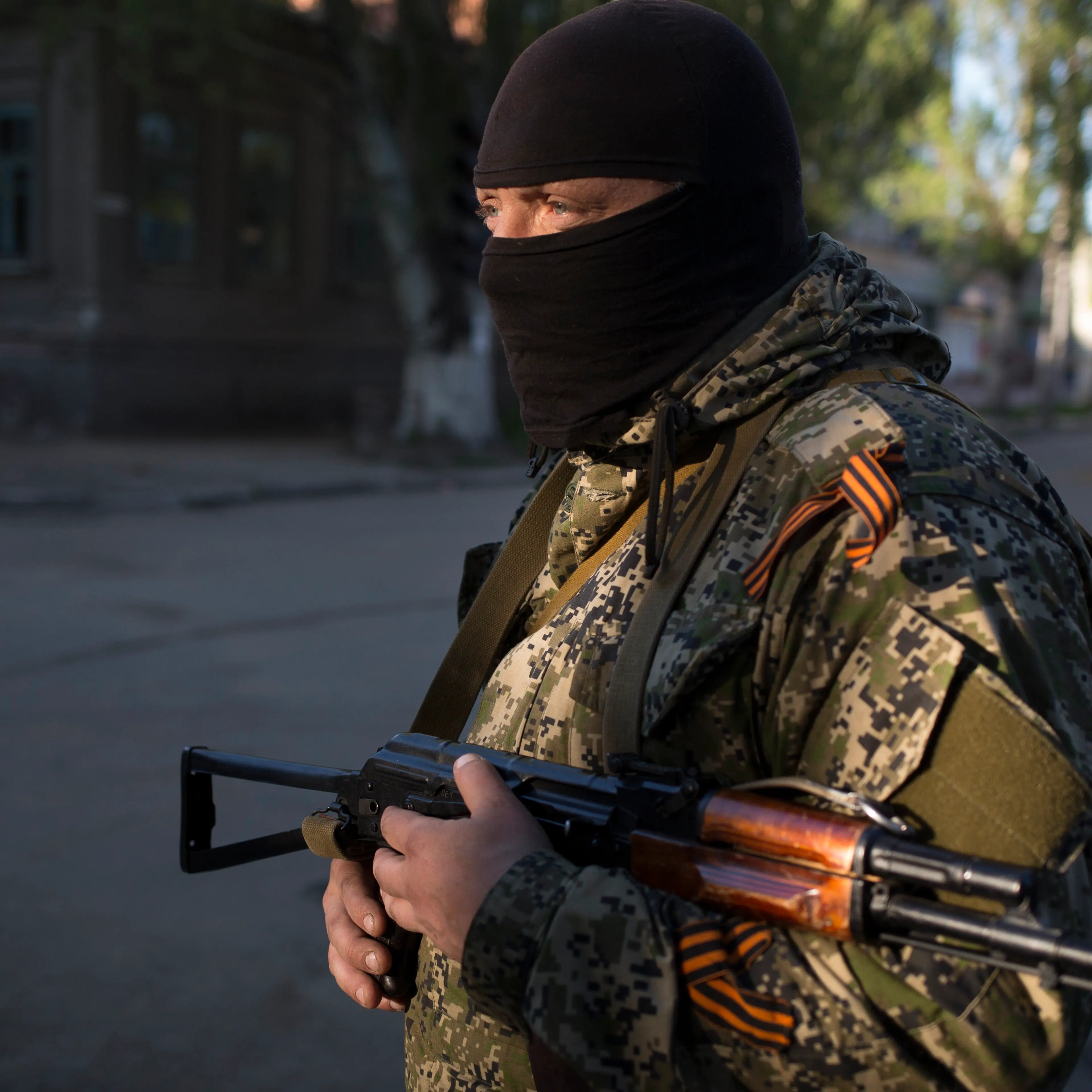 A man guards a road intersection as pro-Russian activists strengthen the barricades in front of the Ukrainian regional office of the Security Service in Slavyansk, May 7, 2014.