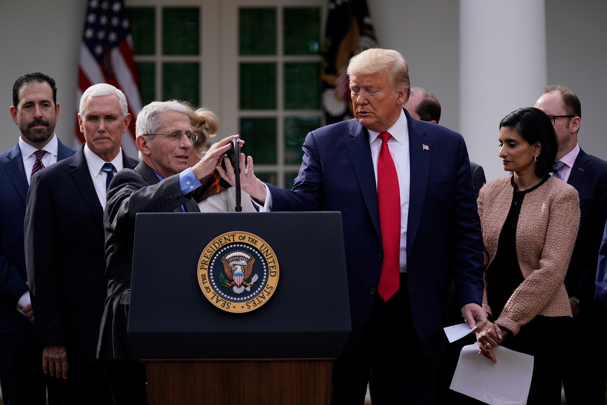 Trump and Fauci, at microphone, address reporters in the Rose Garden on March 13