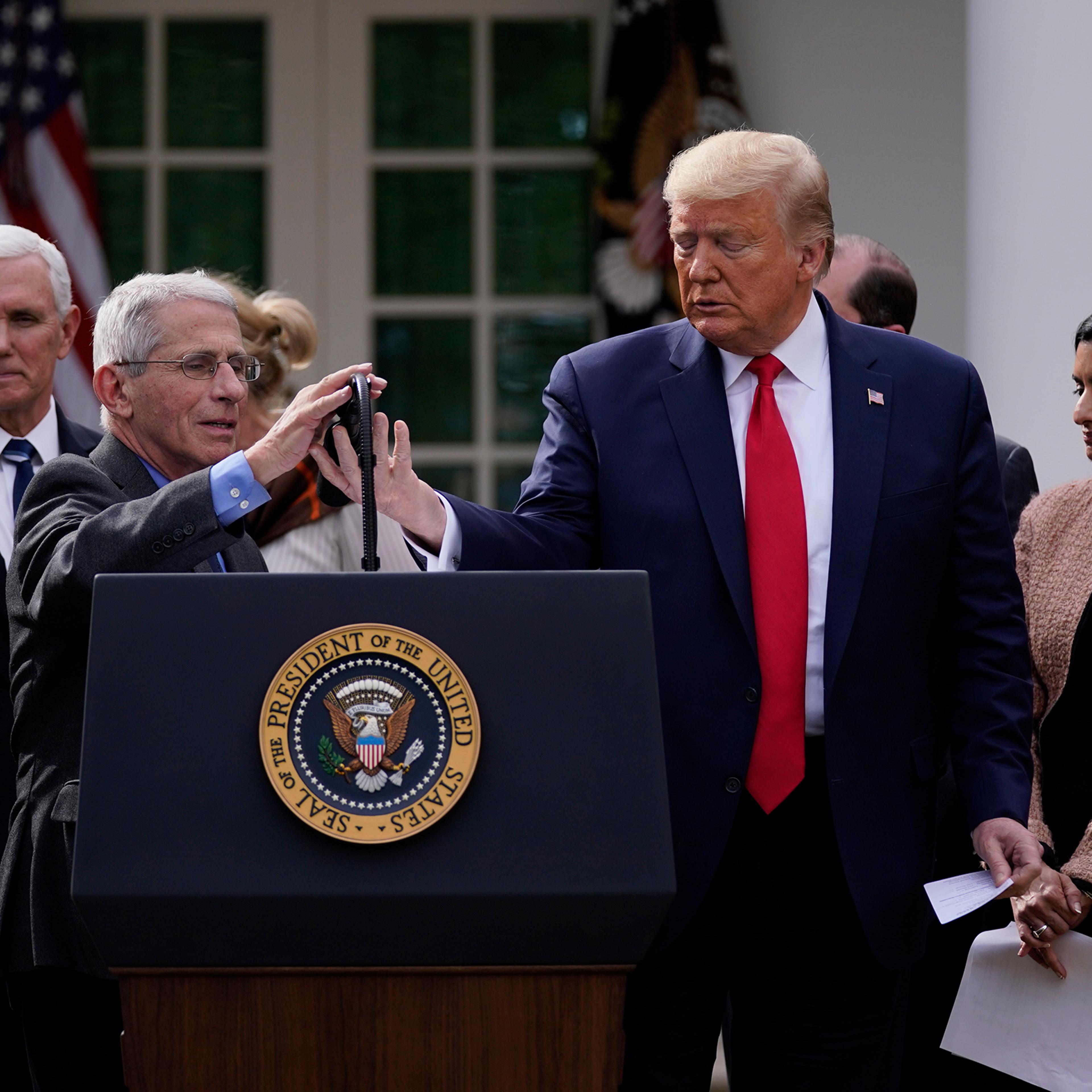 Trump and Fauci, at microphone, address reporters in the Rose Garden on March 13