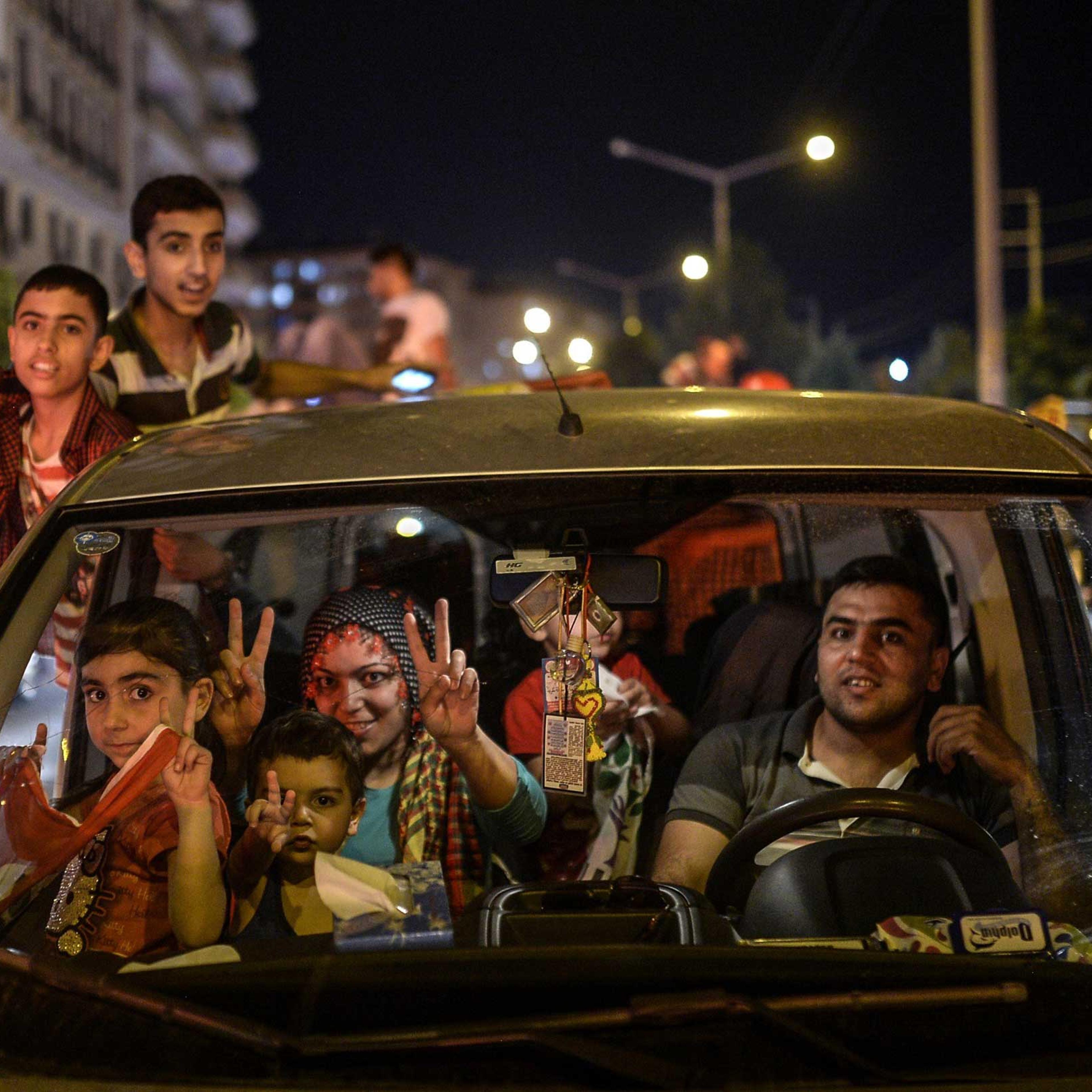 A family and children, supporters of pro-Kurdish Peoples' Democratic Party (HDP) celebrate the results of the legislative election, in Diyarbakir in Turkey on June 7, 2015.