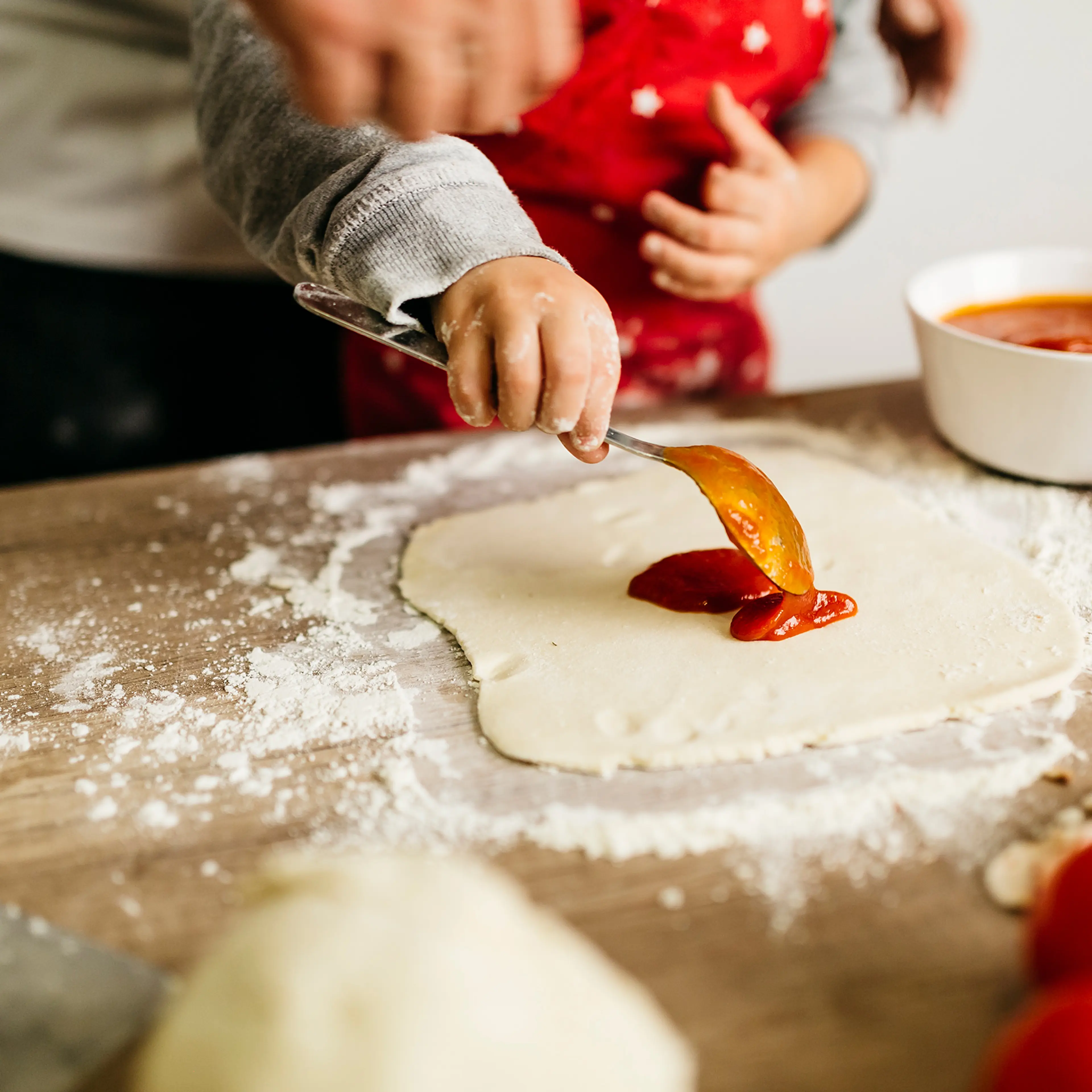 Father and son preparing pizza together