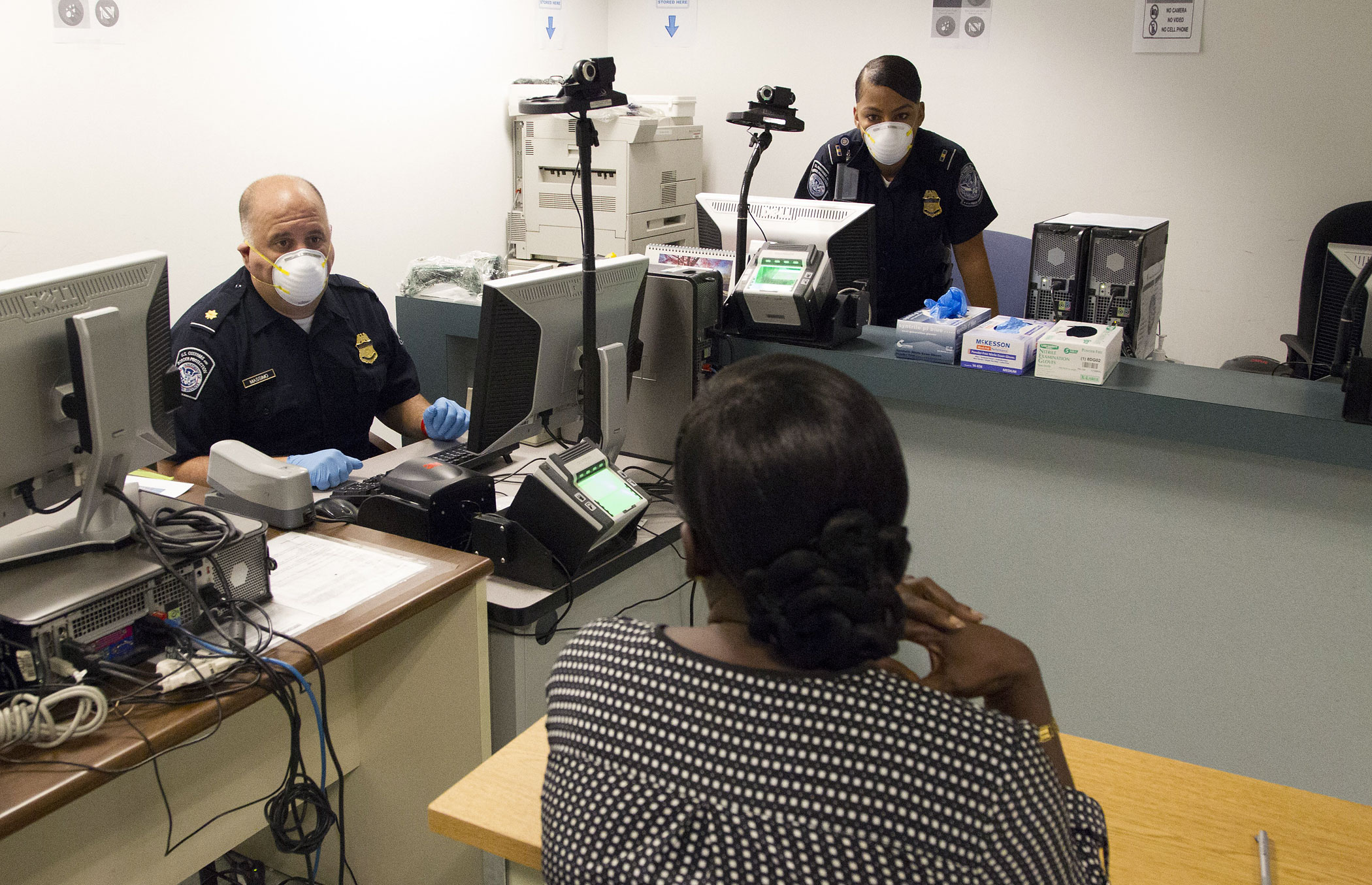 IINTERNATIONAL PASSENGERS BEING SCREENED FOR MEDICAL CONDITIONS RELATED TO EBOLA AT  THE CHICAGO INTERNATIONAL AIRPORT BY MEMBERS OF THE US CUSTOMS AND BOARDER PATROL AND A US COAST GUARD MEDICAL TEAM, BOTH PART OF THE US DEPARTMENT HOMELAND SECURITY. TH