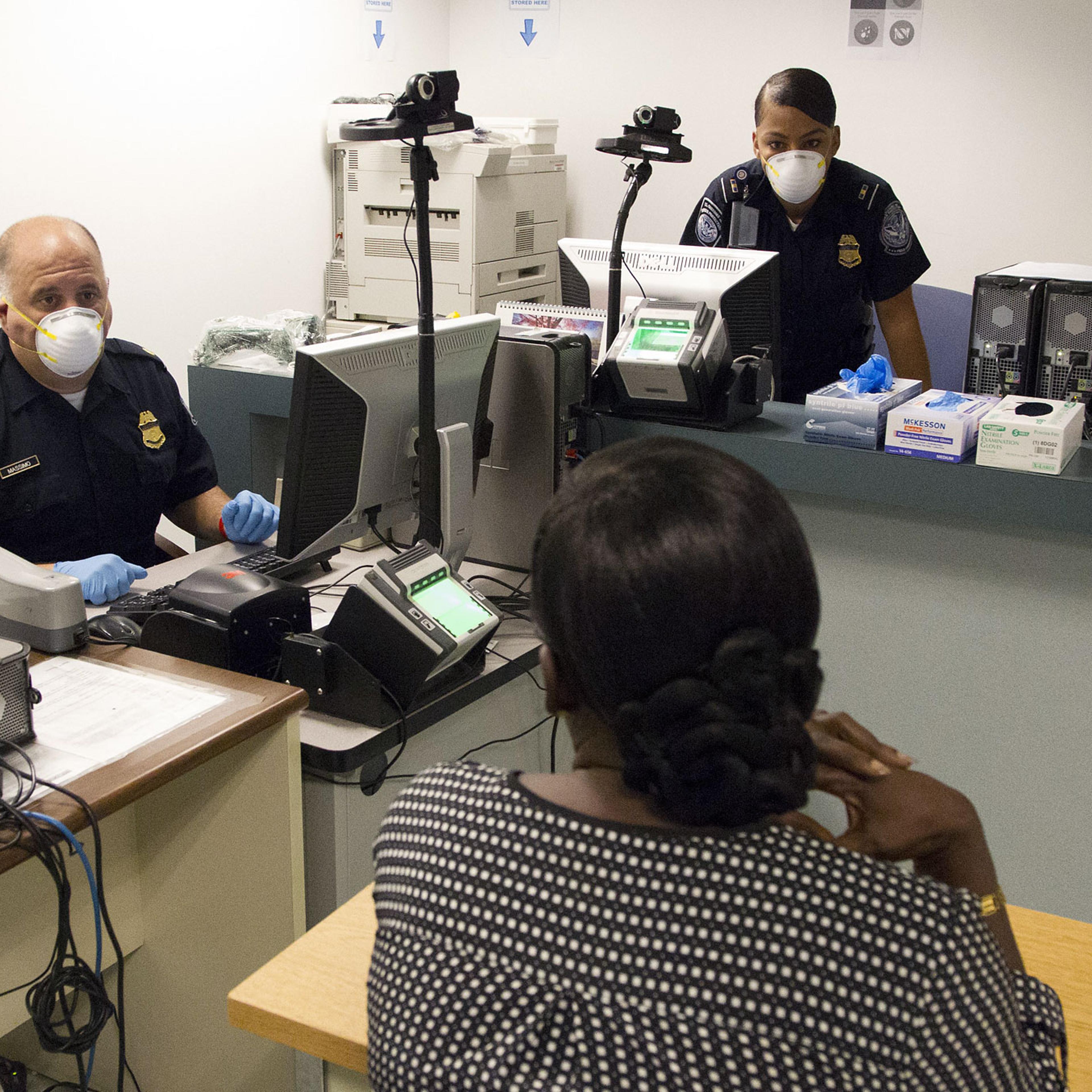 IINTERNATIONAL PASSENGERS BEING SCREENED FOR MEDICAL CONDITIONS RELATED TO EBOLA AT THE CHICAGO INTERNATIONAL AIRPORT BY MEMBERS OF THE US CUSTOMS AND BOARDER PATROL AND A US COAST GUARD MEDICAL TEAM, BOTH PART OF THE US DEPARTMENT HOMELAND SECURITY. TH