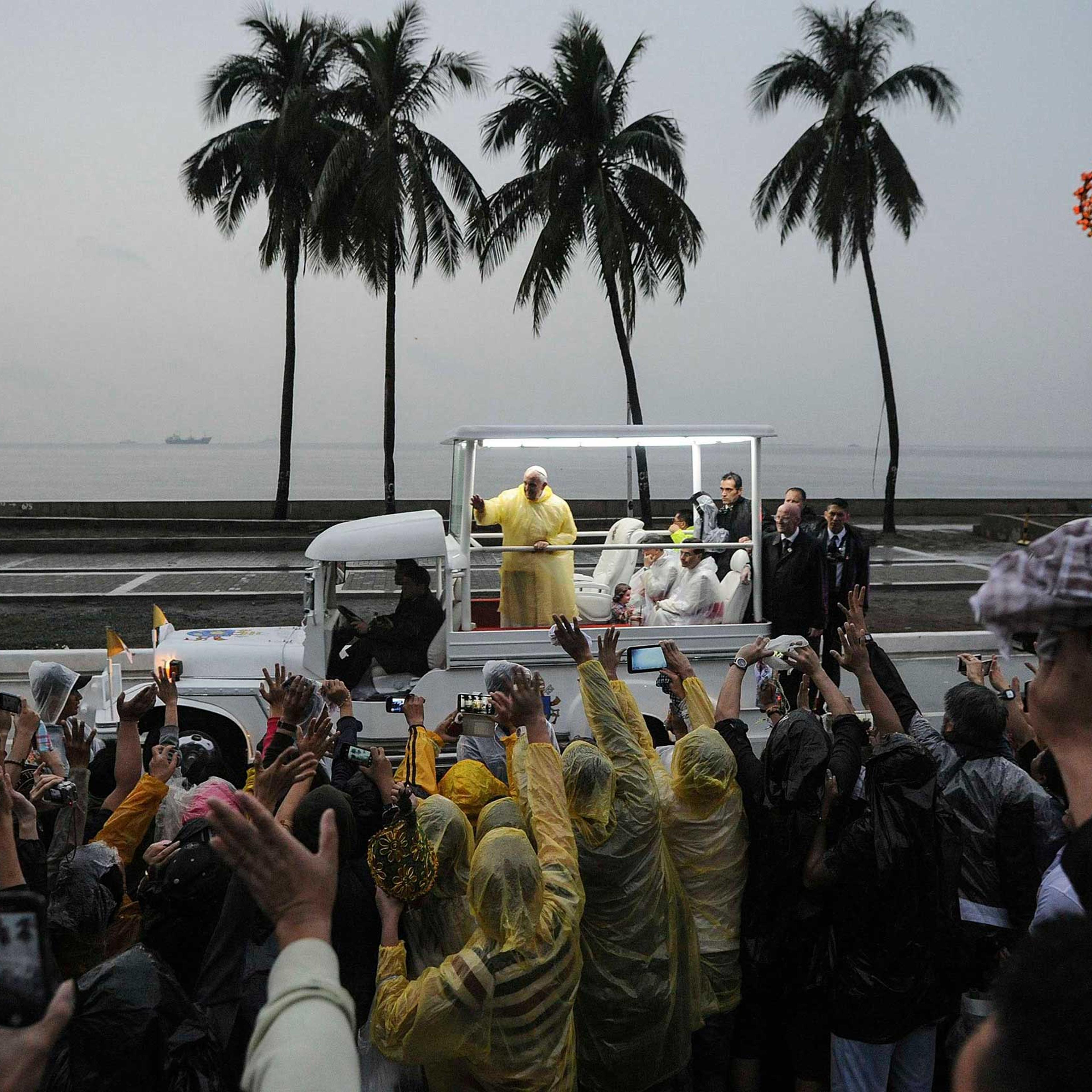 Pope Francis waves from the popemobile after leading a Mass at Rizal Park in Manila, Jan. 18, 2015.