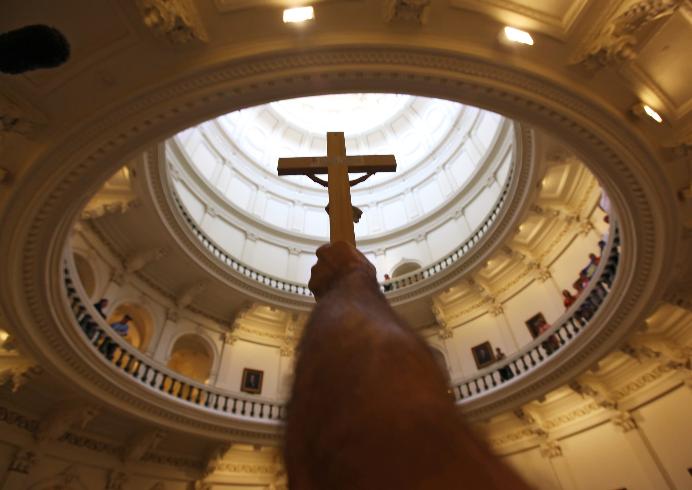 A pro-life supporter holds up a crucifix at the Texas State capitol on Jul. 1, 2013 in Austin
