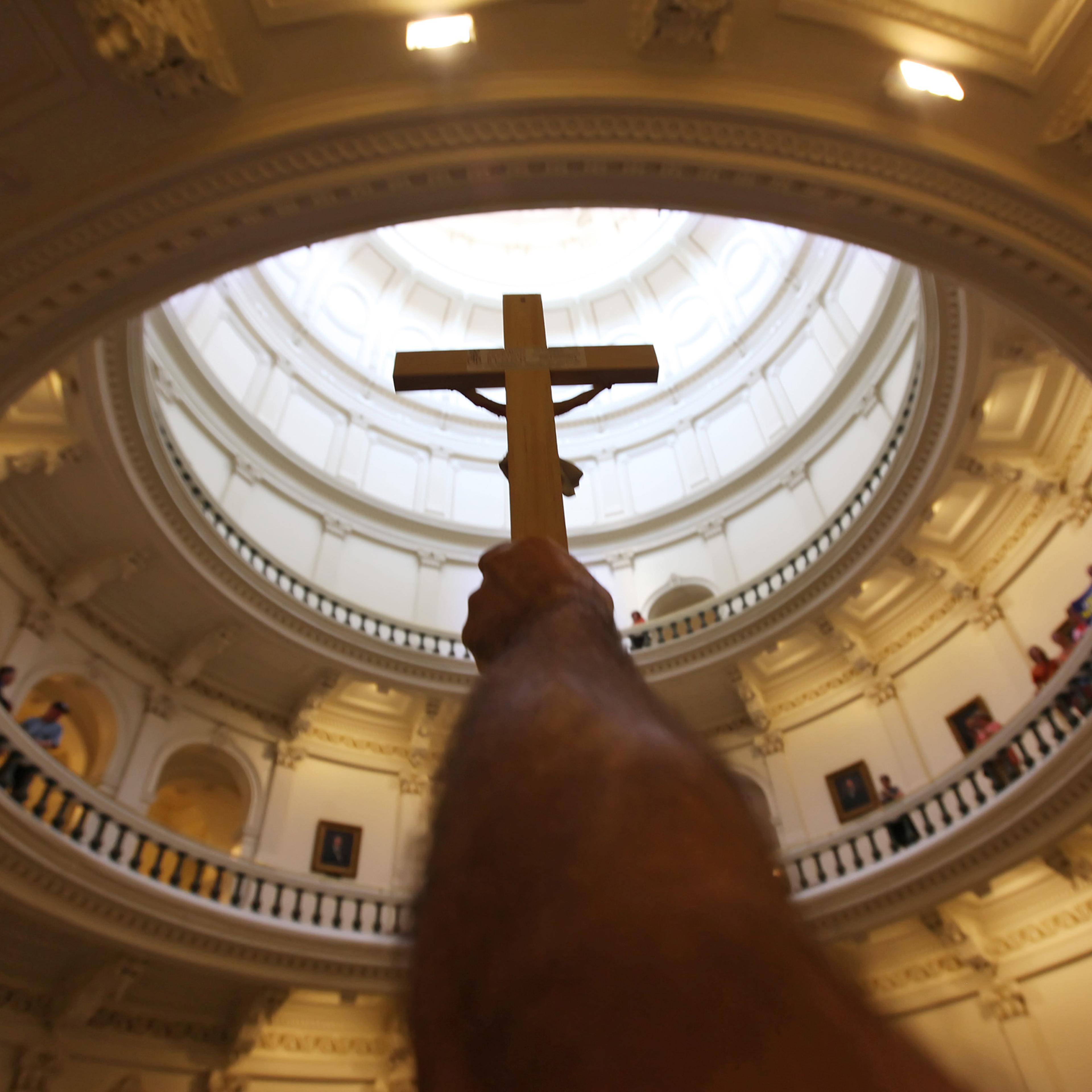 A pro-life supporter holds up a crucifix at the Texas State capitol on Jul. 1, 2013 in Austin