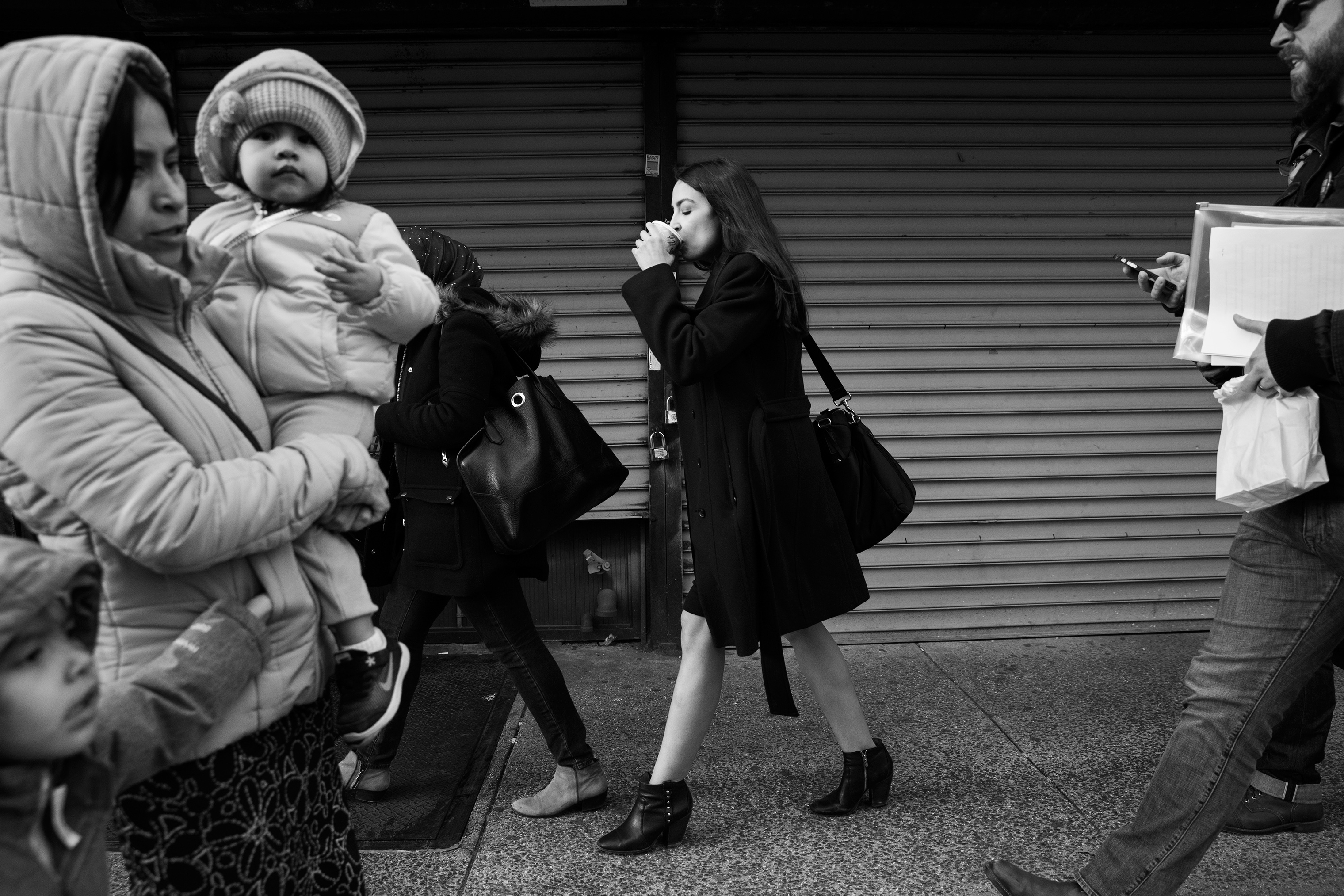 Ocasio-Cortez, sips a coffee on the way back to her district office in Jackson Heights, Queens.
