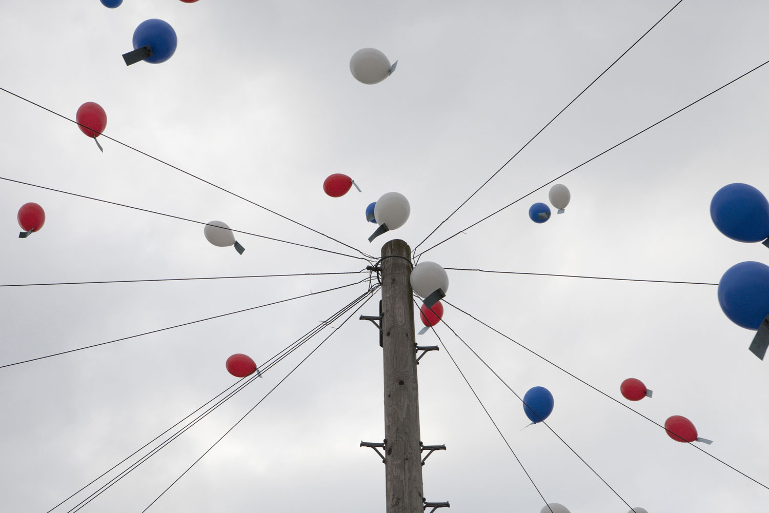 Red, white and blue balloons are raise into the sky at a Hobart Drive Street Party in Walsall, England.