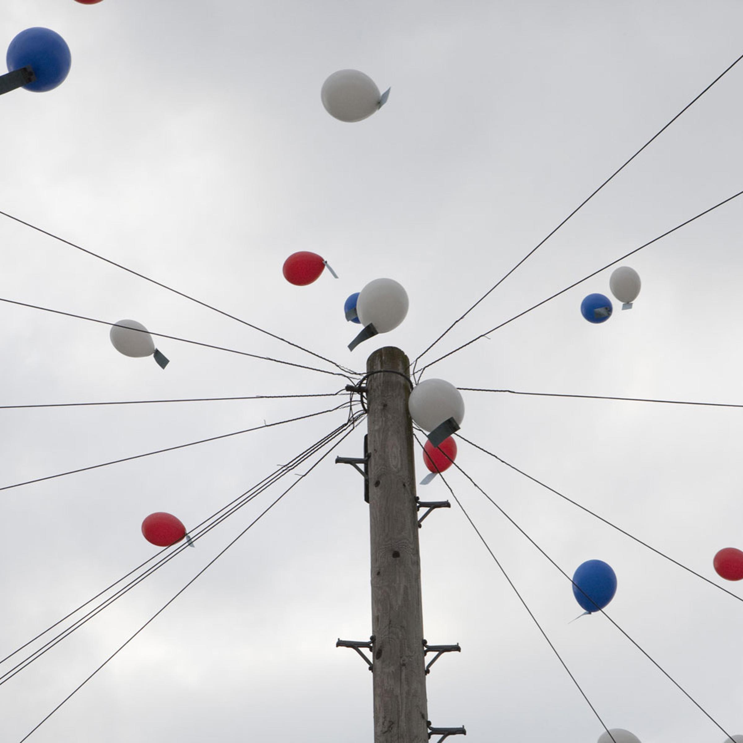 Red, white and blue balloons are raise into the sky at a Hobart Drive Street Party in Walsall, England.
