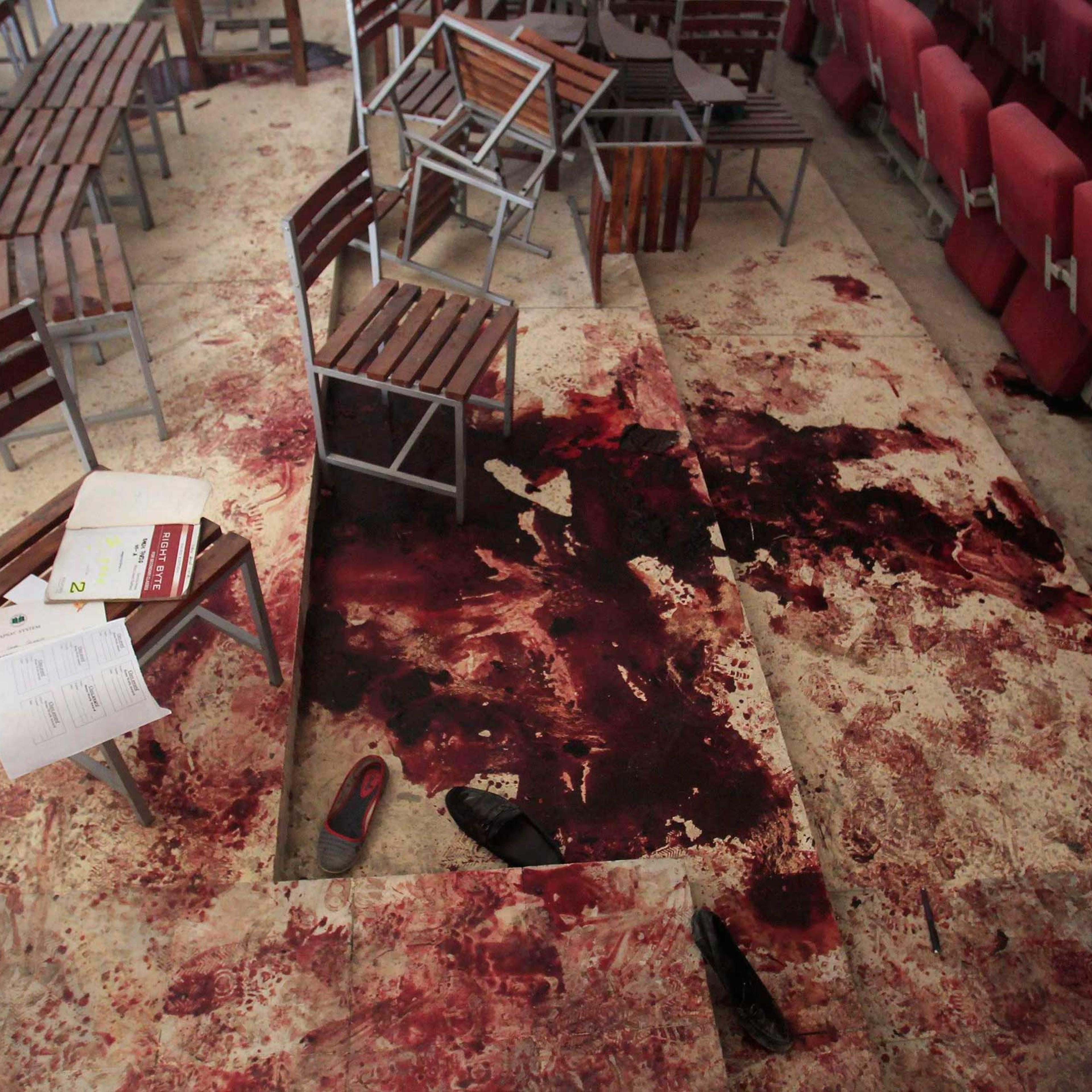 Shoes lie in blood on the auditorium floor at the Army Public School, which was attacked by Taliban gunmen, in Peshawar, Dec. 17, 2014.