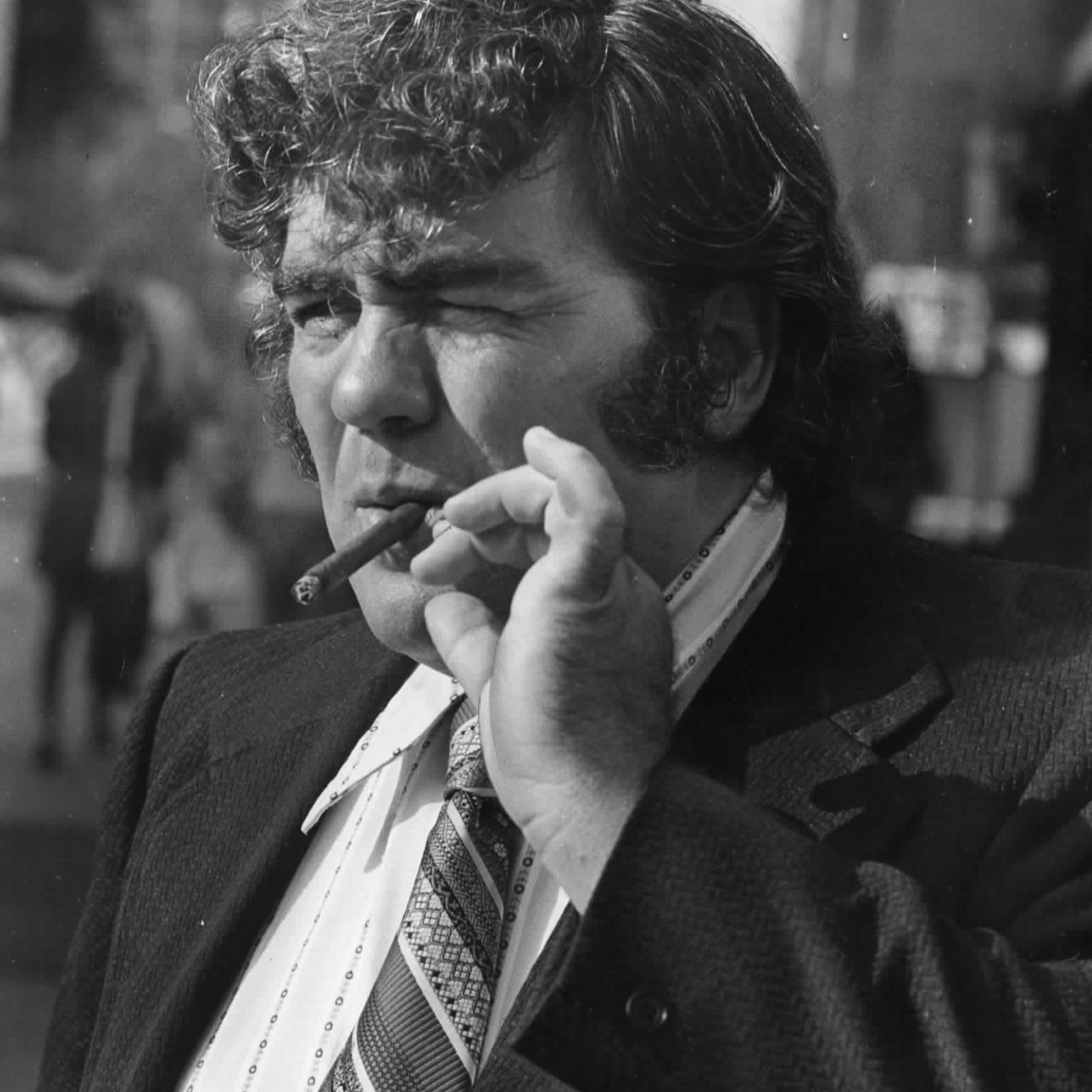 Writer Jimmy Breslin smokes a cigar outside the Madison Hotel