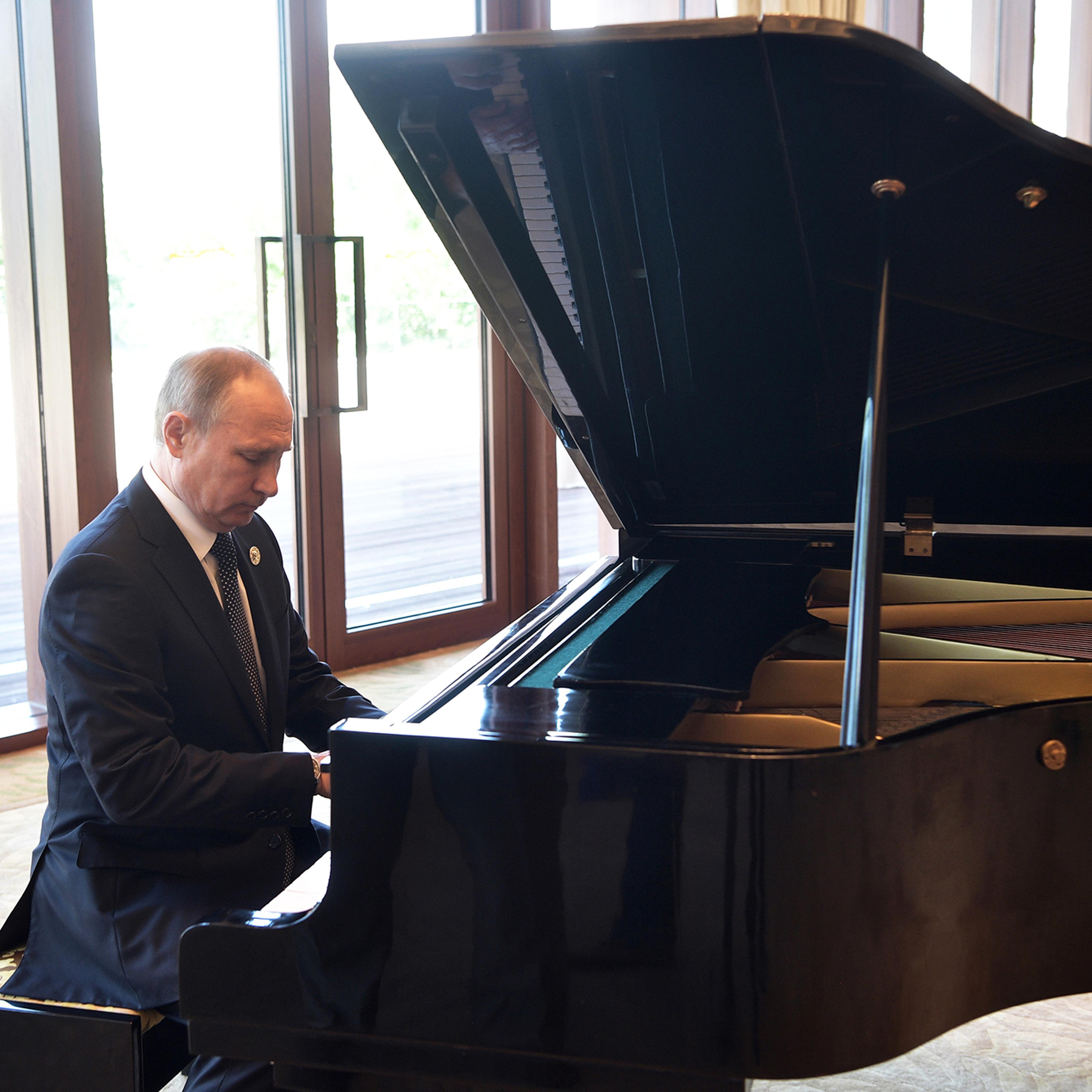 Russian President Vladimir Putin plays piano before his talks with Chinese President Xi Jinping prior to the opening ceremony of the Belt and Road Forum in Beijing, on May 14, 2017.