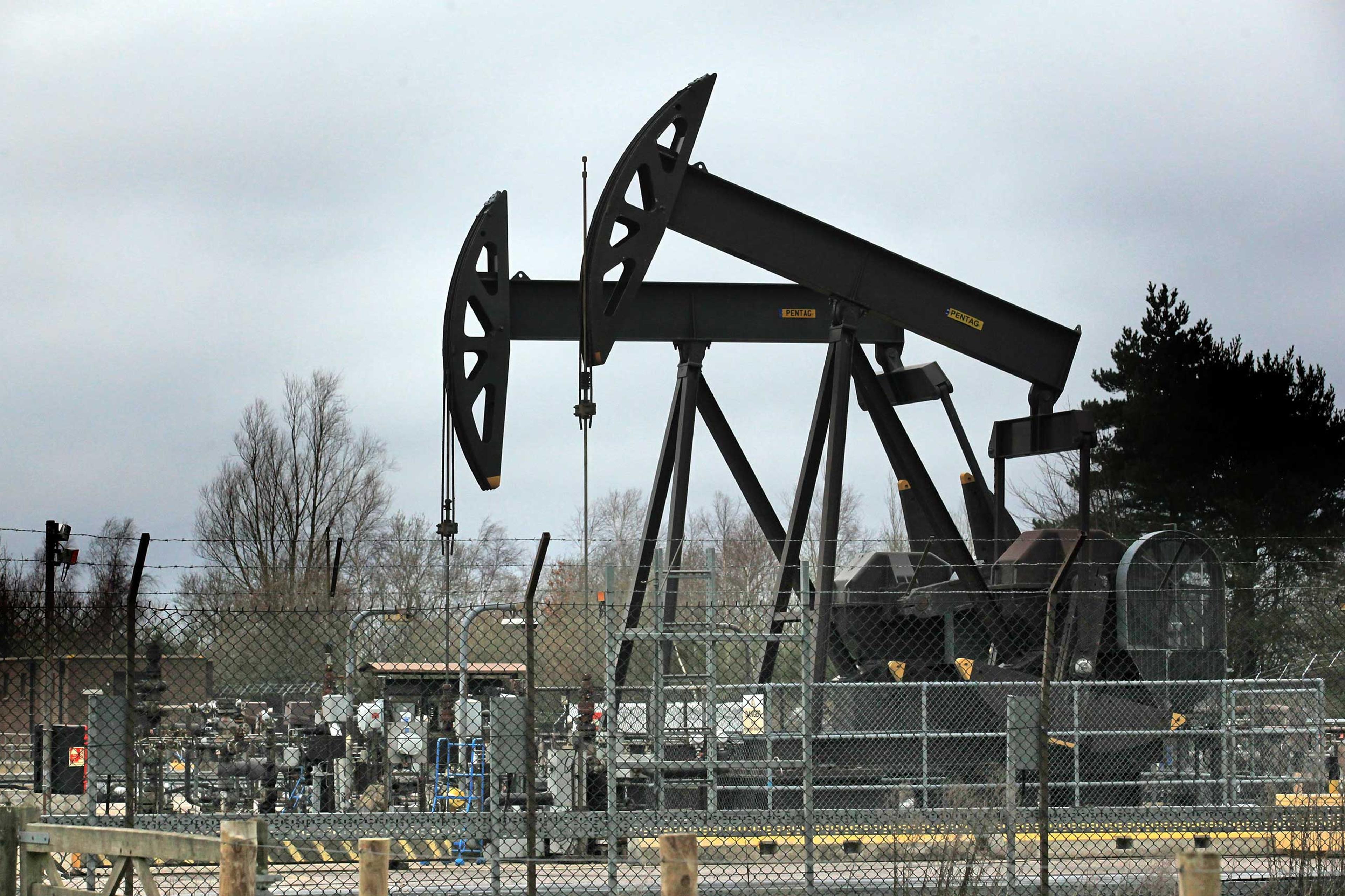 Nodding donkey pumping units work at one of the oil wells at western Europe's largest onshore oil field near Poole, United Kingdom, in 2011.