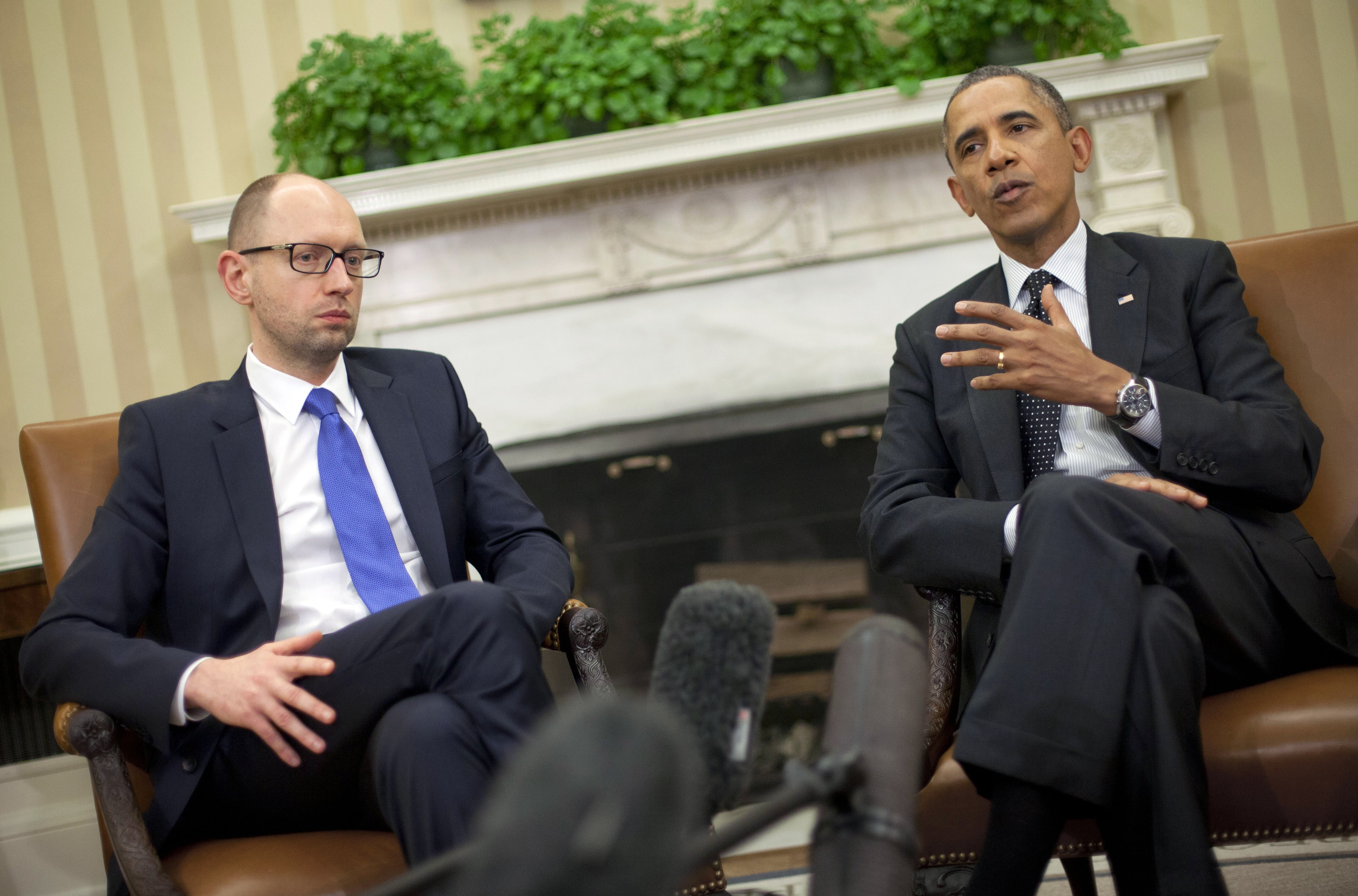 President Barack Obama, right, with Ukraine Prime Minister Arseniy Yatsenyuk, left, talk in the Oval Office of the White House in Washington