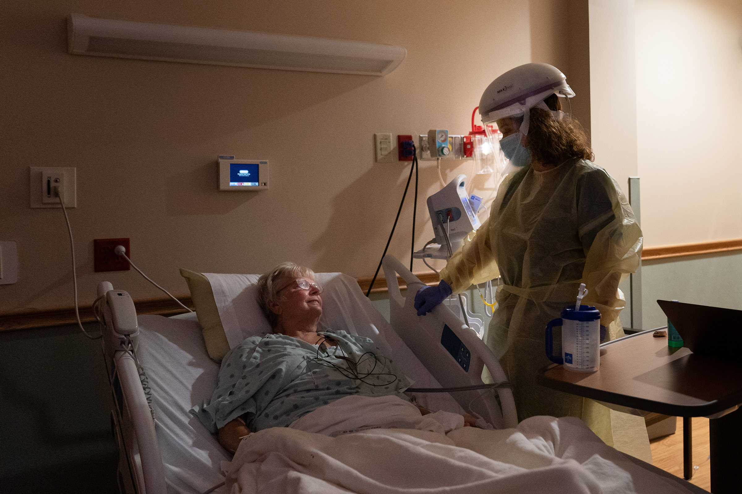 Dr. Rebecca Martin talks with Barbara Billigmeier, a patient hospitalized with COVID-19, at Baxter Regional Medical Center in Mountain Home, Ark., on July 8, 2021. Despite her ordeal, Billigmeier said, she hasn't changed her mind about getting vaccinated