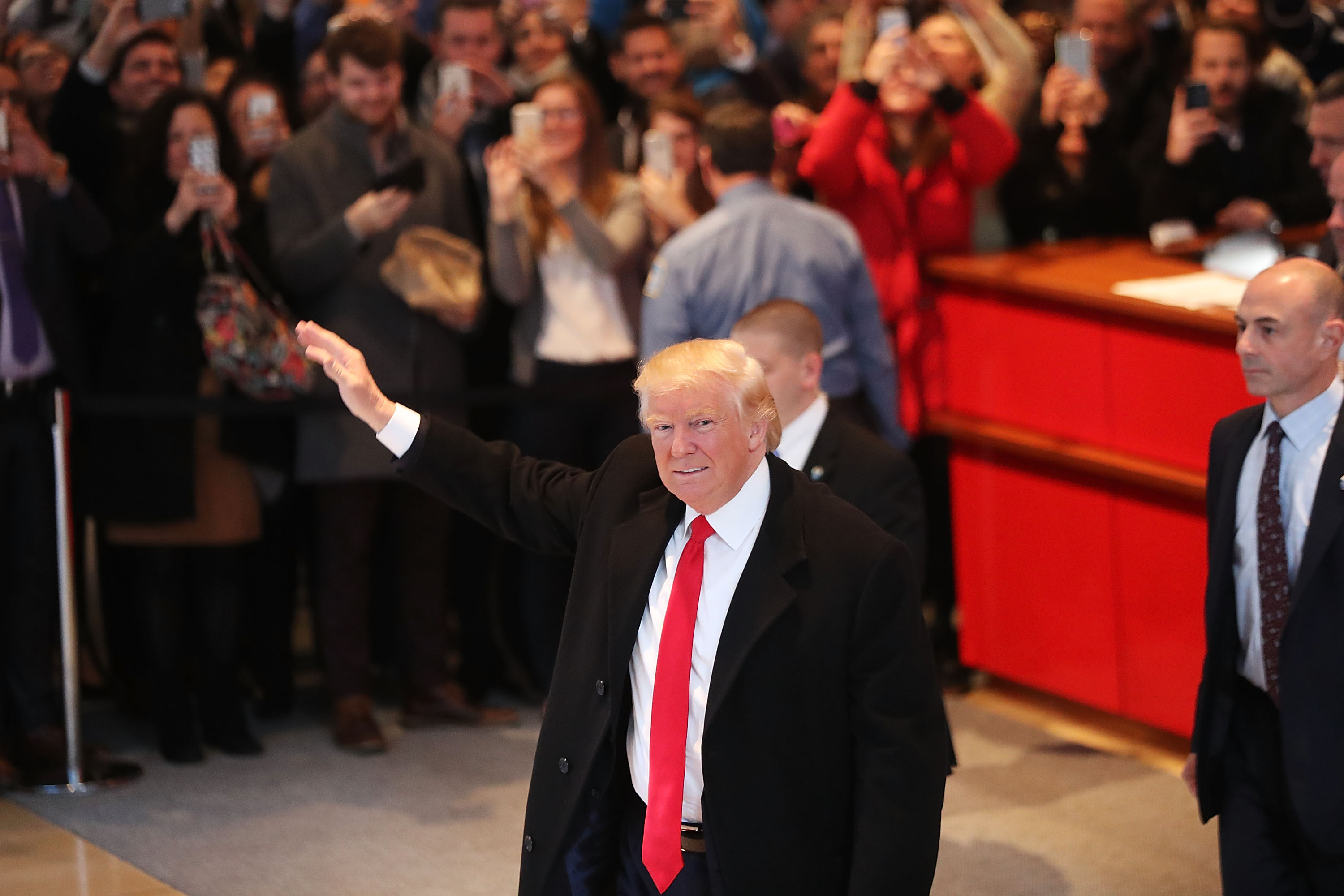 President-elect Donald Trump walks through the lobby of the New York Times following a meeting with editors at the paper in New York City on Nov. 22, 2016.