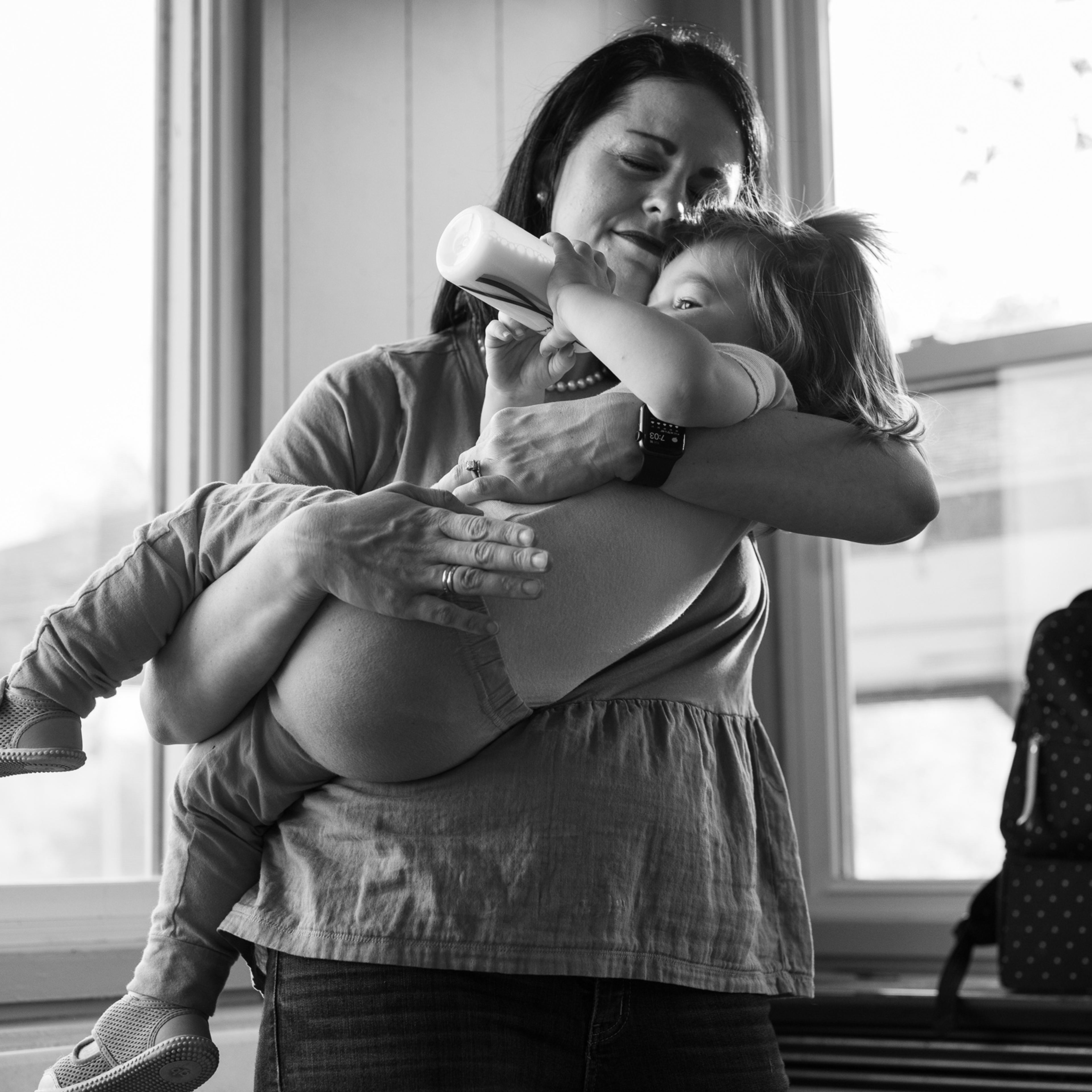 Misti Allison holds her daughter Audrey at a press conference organized to hear residents demands and health concerns following the toxic train derailment in East Palestine, Ohio, on May 16, 2023