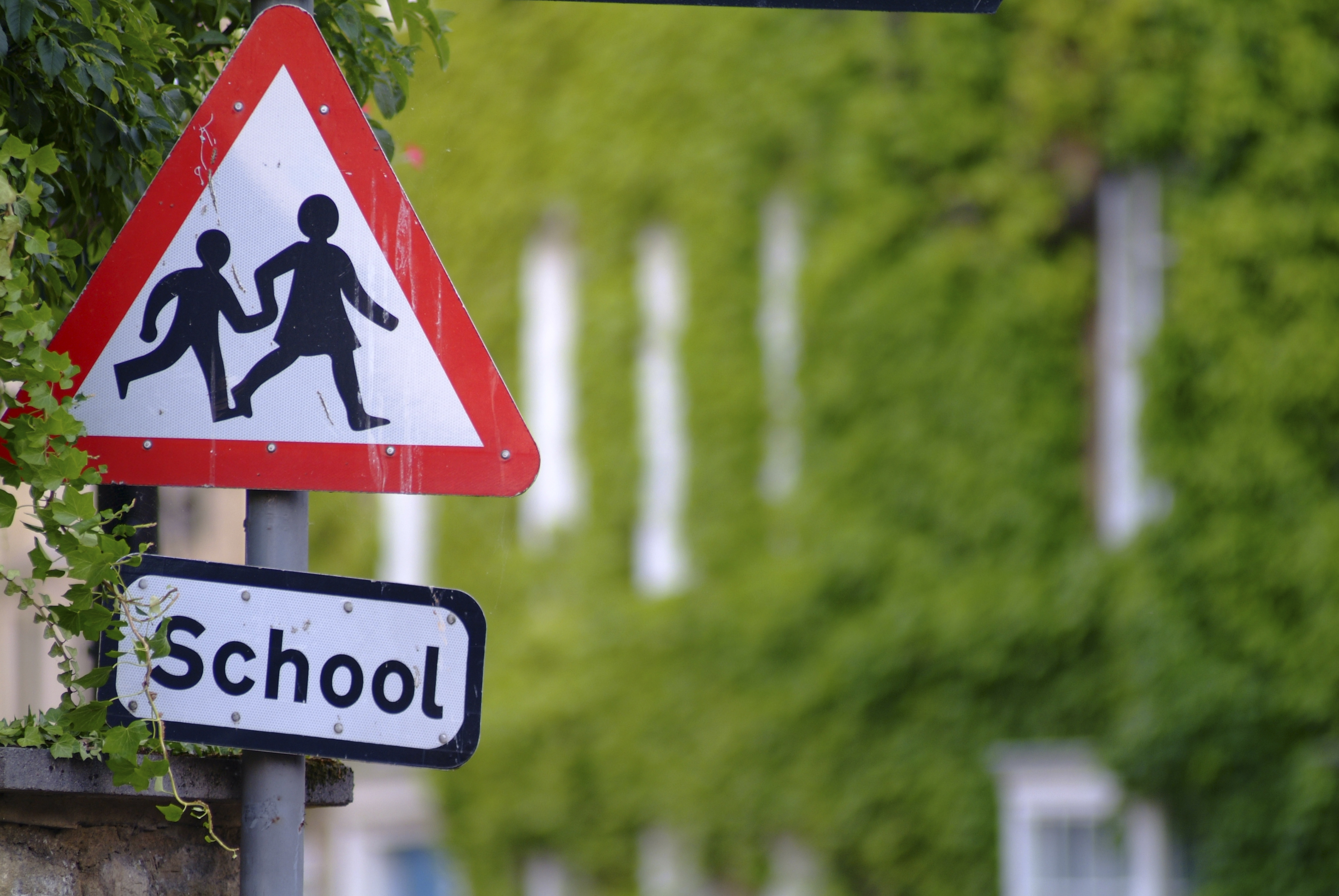 A road-sign warning drivers to slow down as they approach a school in Oundle. Oundle is an ancient Northamptonshire market town, attractively situated on rising ground beside a meander of the River Nene., Oundle, Northamptonshire, England. Additional Cre