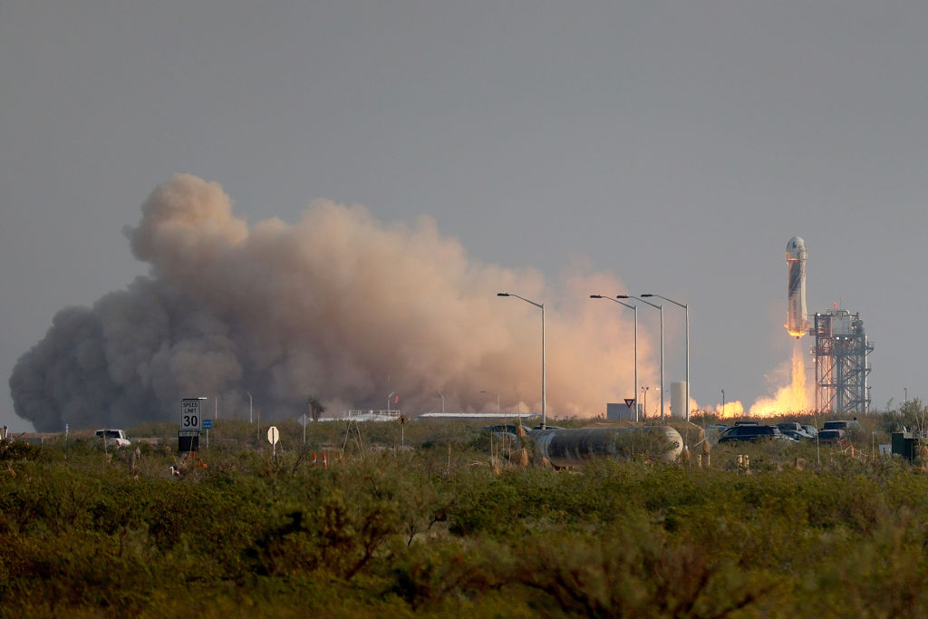 The New Shepard Blue Origin rocket lifts-off from the launch pad carrying Jeff Bezos along with his brother Mark Bezos, 18-year-old Oliver Daemen, and 82-year-old Wally Funk on July 20, 2021 in Van Horn, Texas.